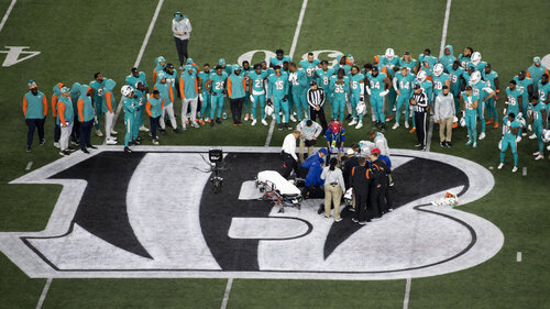 Teammates gather around Miami Dolphins quarterback Tua Tagovailoa (1) after an injury during the first half of an NFL football game against the Cincinnati Bengals, Thursday, Sept. 29, 2022, in Cincinnati.