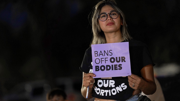 Celina Washburn protests outside the Arizona Capitol to voice her dissent with an abortion ruling, on Sept. 23, 2022, in Phoenix.