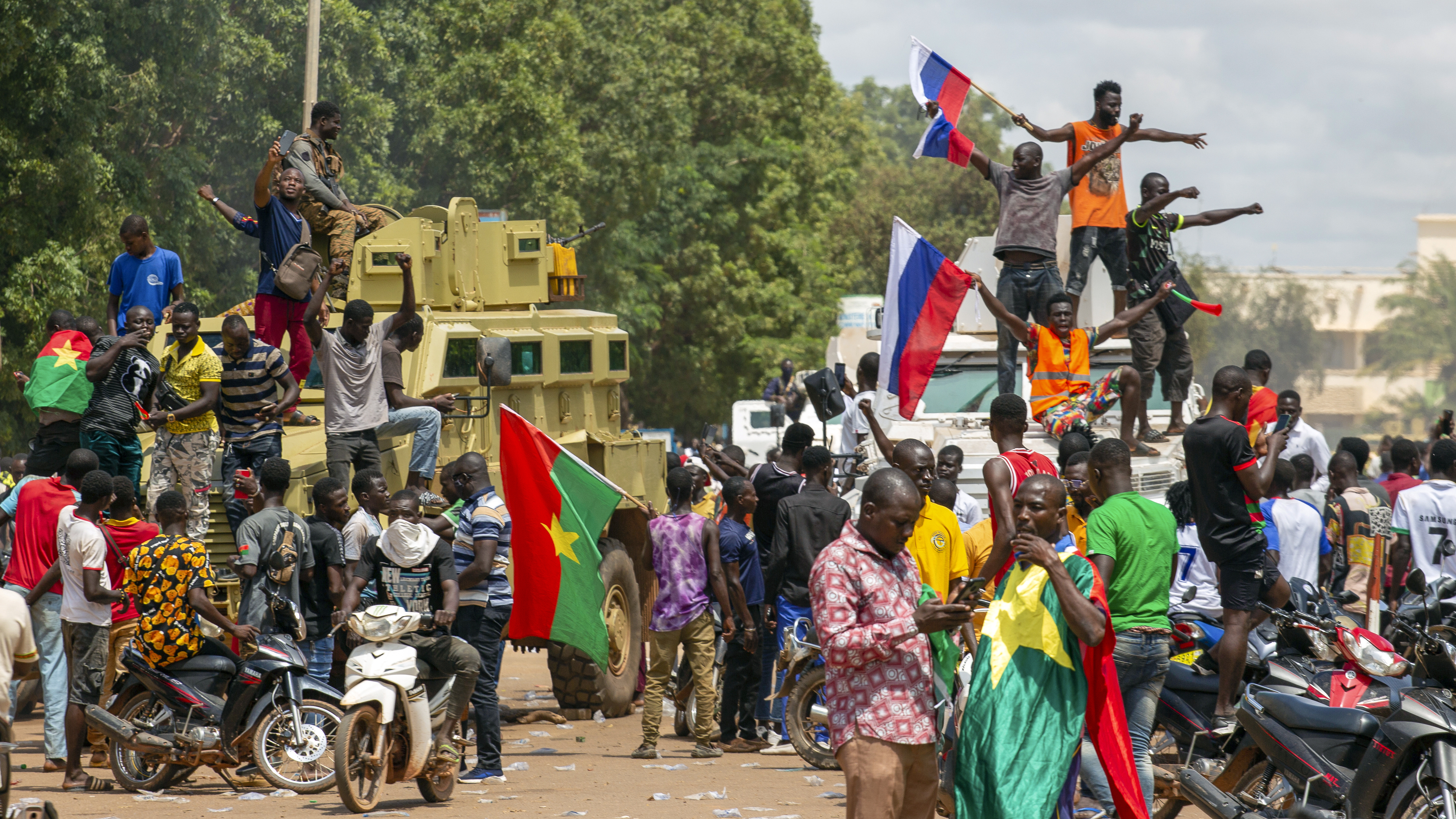 Supporters of Capt. Ibrahim Traore cheer with Russian flags in the streets of Ouagadougou, Burkina Faso, on Sunday. Burkina Faso