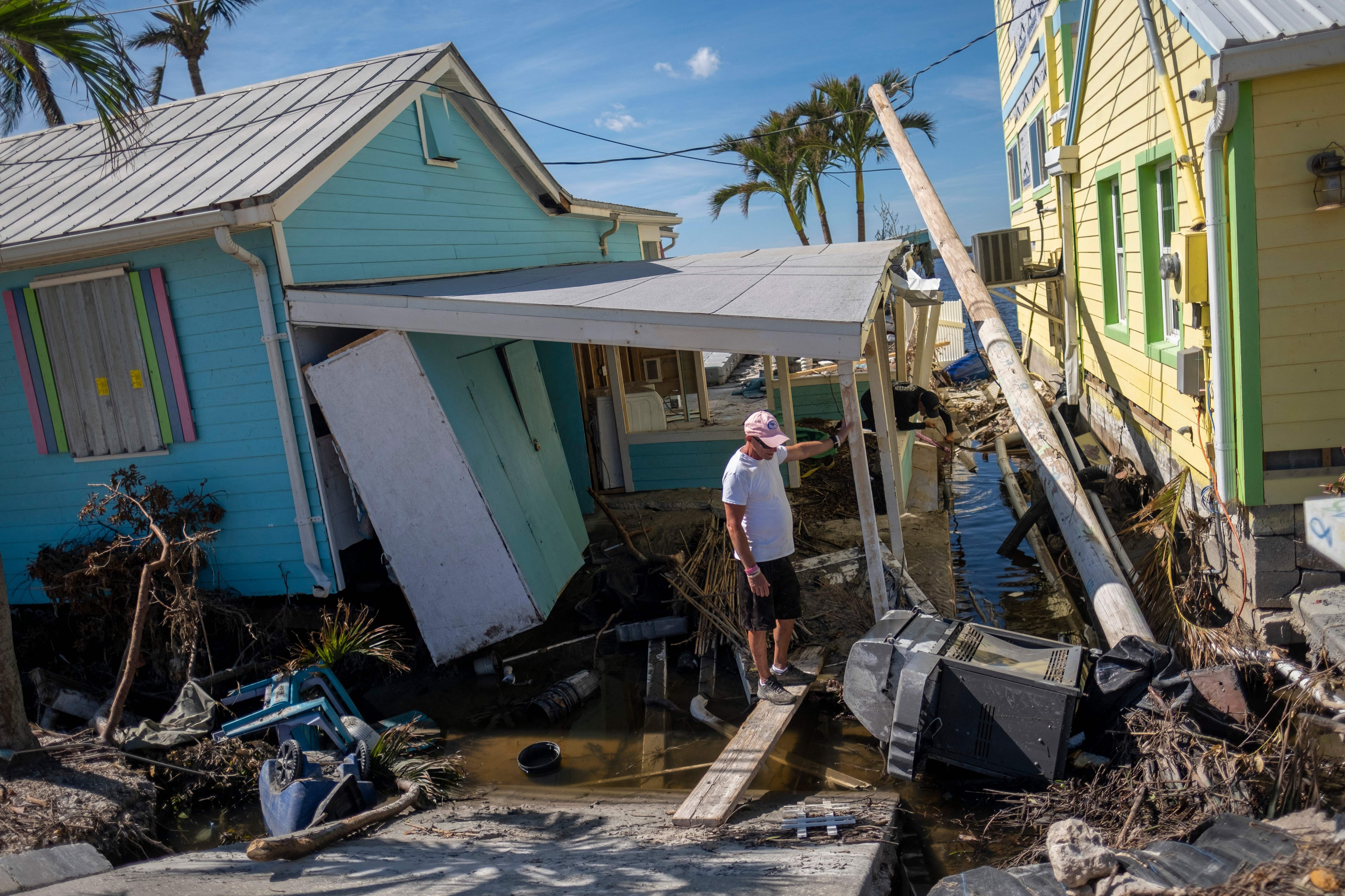 A man stands in front of his destroyed house in the aftermath of Hurricane Ian in Matlacha, Fla., on Oct. 3. (AFP/Getty Images)