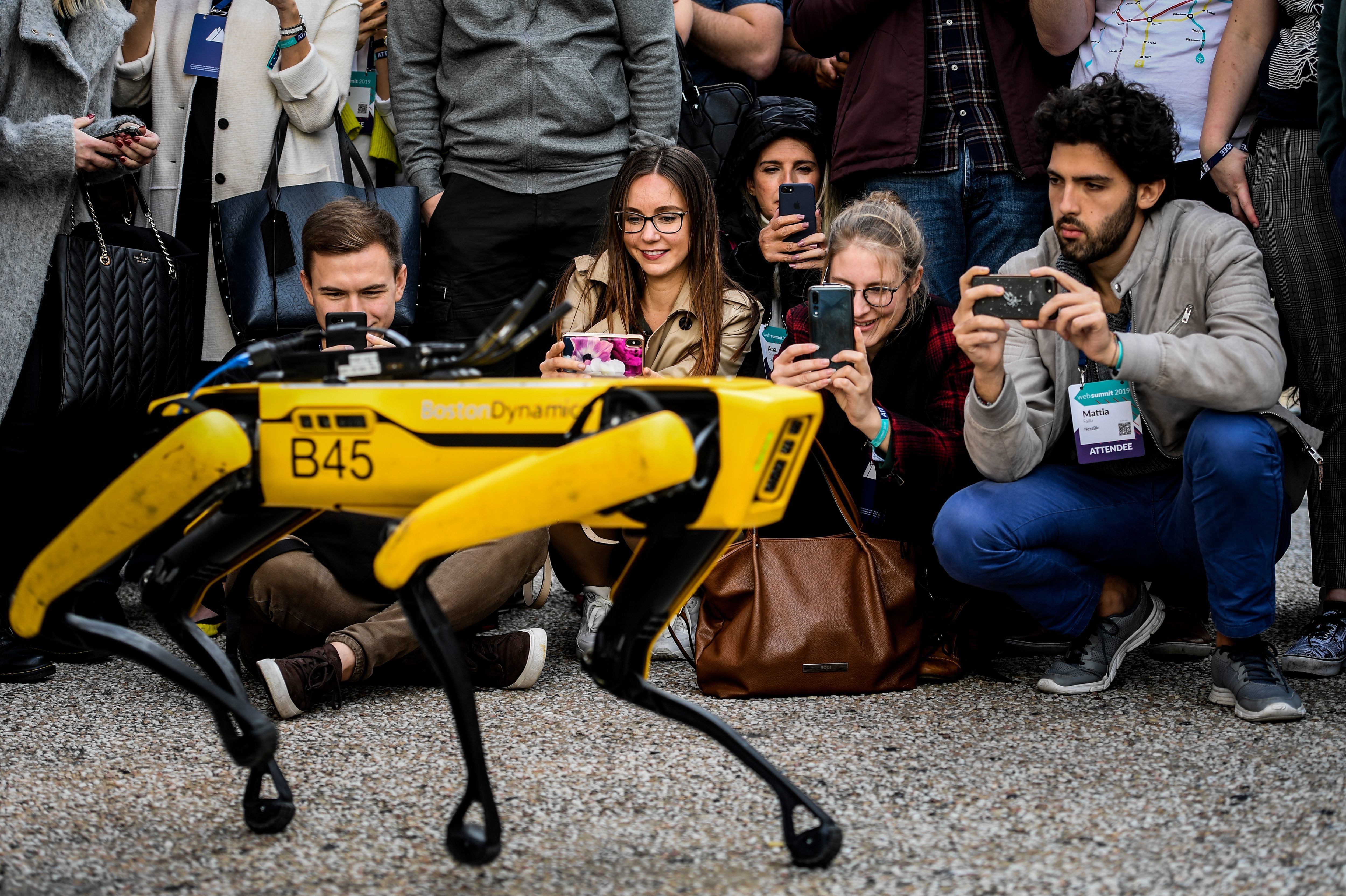 People take pictures and videos of the Boston Dynamics robot Spot during an event in Lisbon in 2019. (AFP via Getty Images)