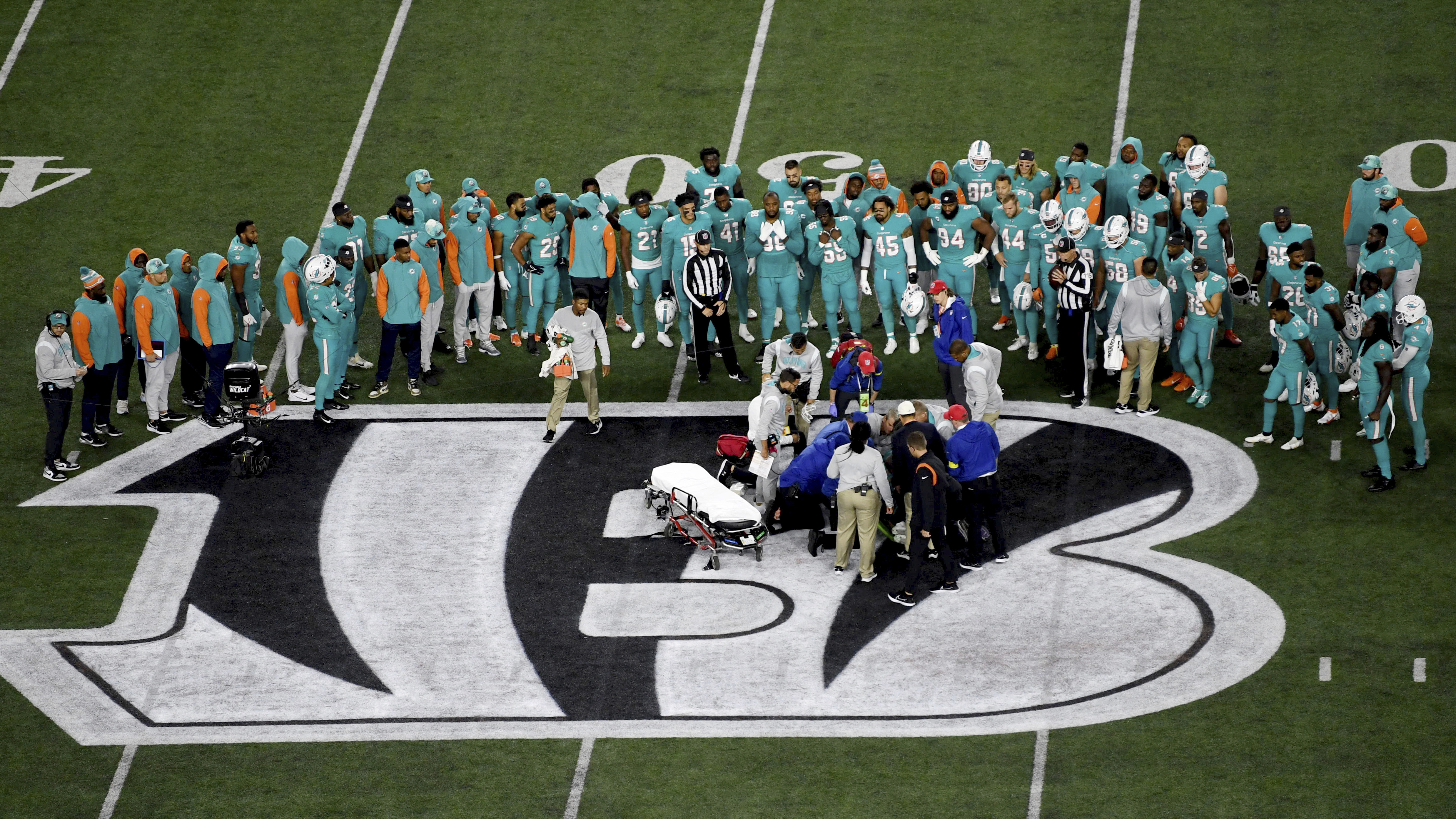 Teammates gather around Miami Dolphins quarterback Tua Tagovailoa after an injury on Sept. 29 in Cincinnati. The NFL and NFL Players Association agreed to modify the league
