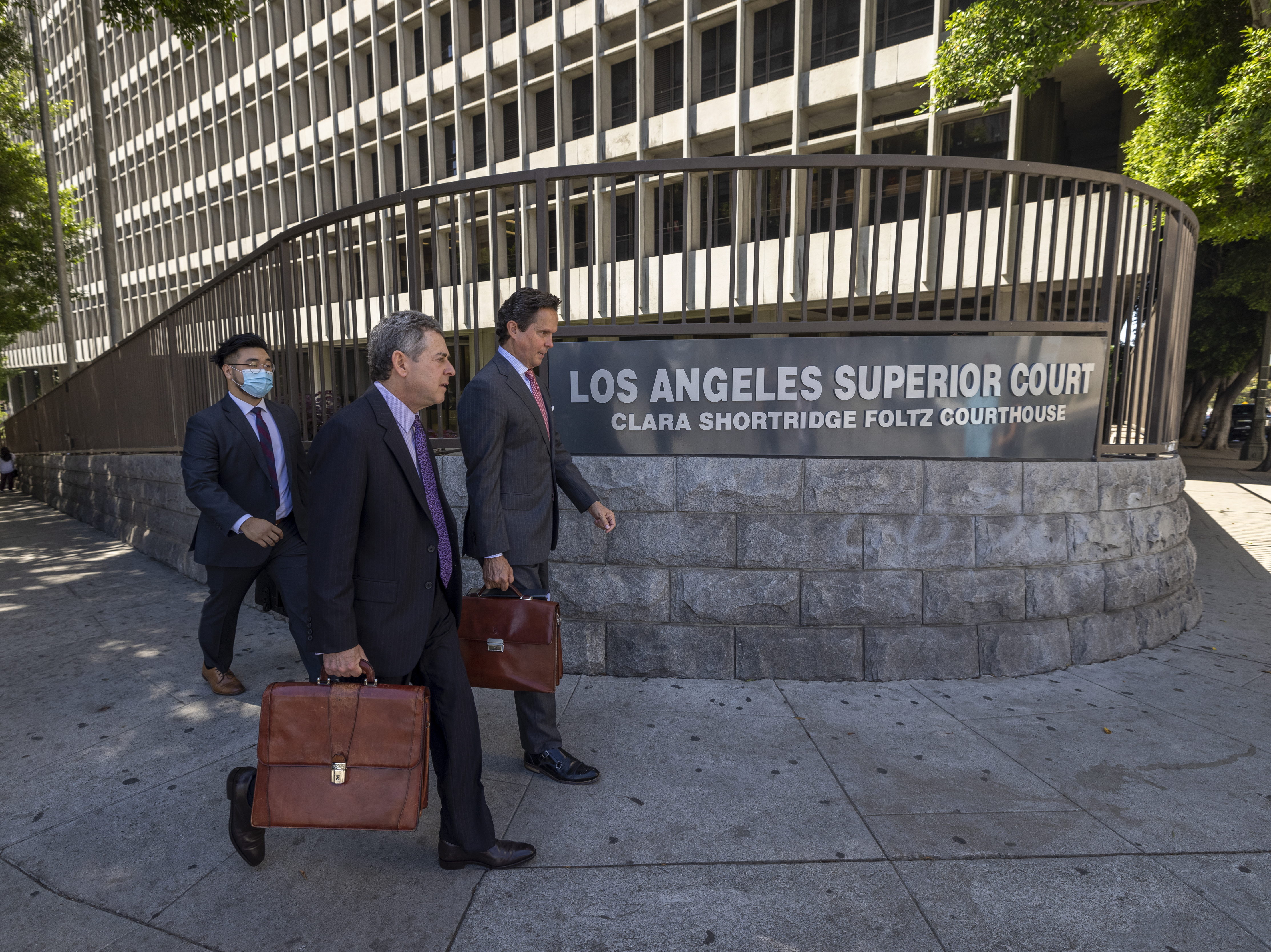 Mark Werksman (C) and Alan Jackson (R), attorneys for Harvey Weinstein, walk from Clara Shortridge Foltz Criminal Justice Center.