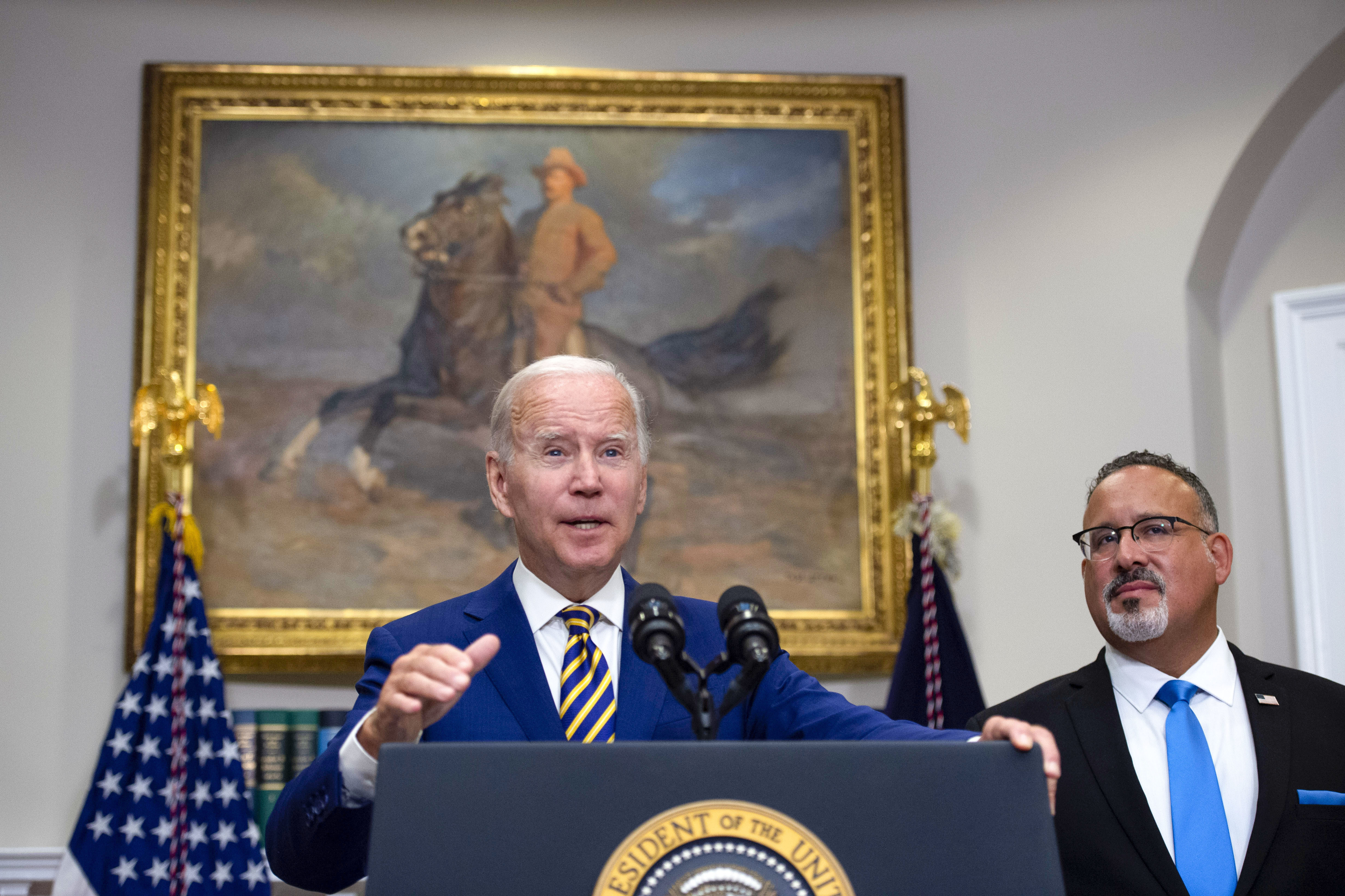President Biden and U.S. Education Secretary Miguel Cardona announced a sweeping plan for student debt relief in August. (Bloomberg via Getty Images)