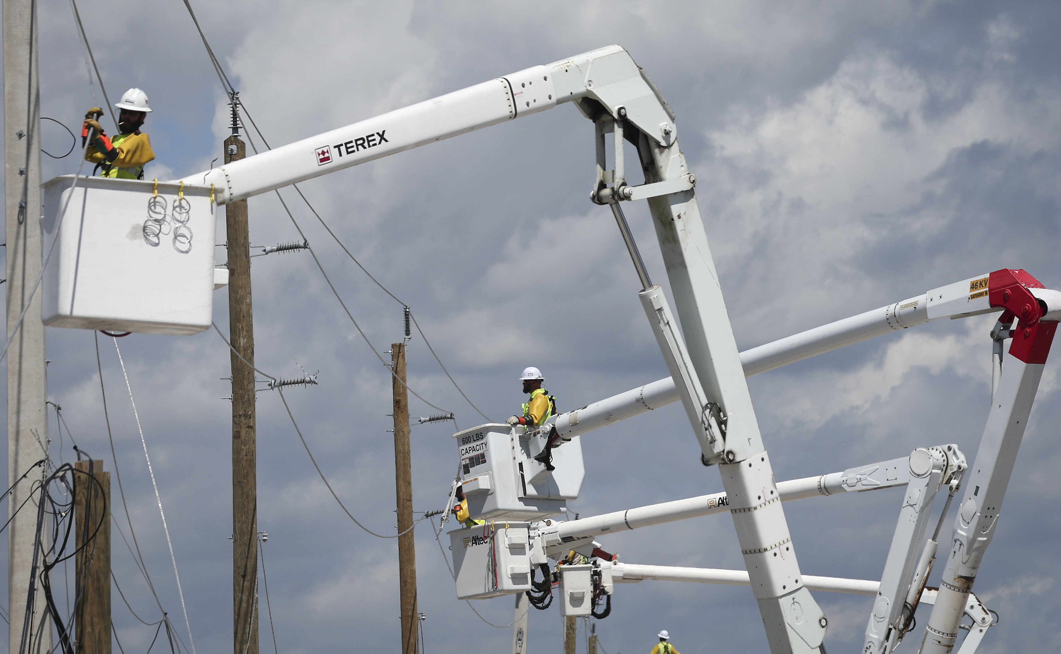 Power crews work to restore electricity in the wake of Hurricane Ian on Oct. 6 on San Carlos Island, in Florida's Lee County. (Getty Images)