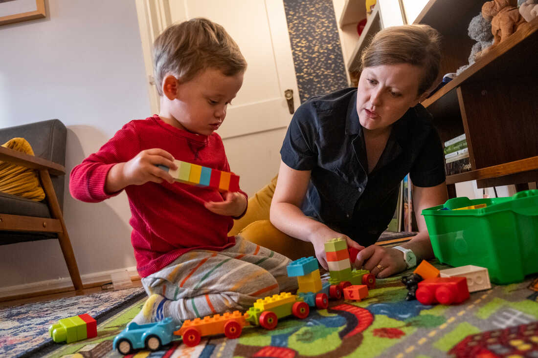 Parent and child playing with toys