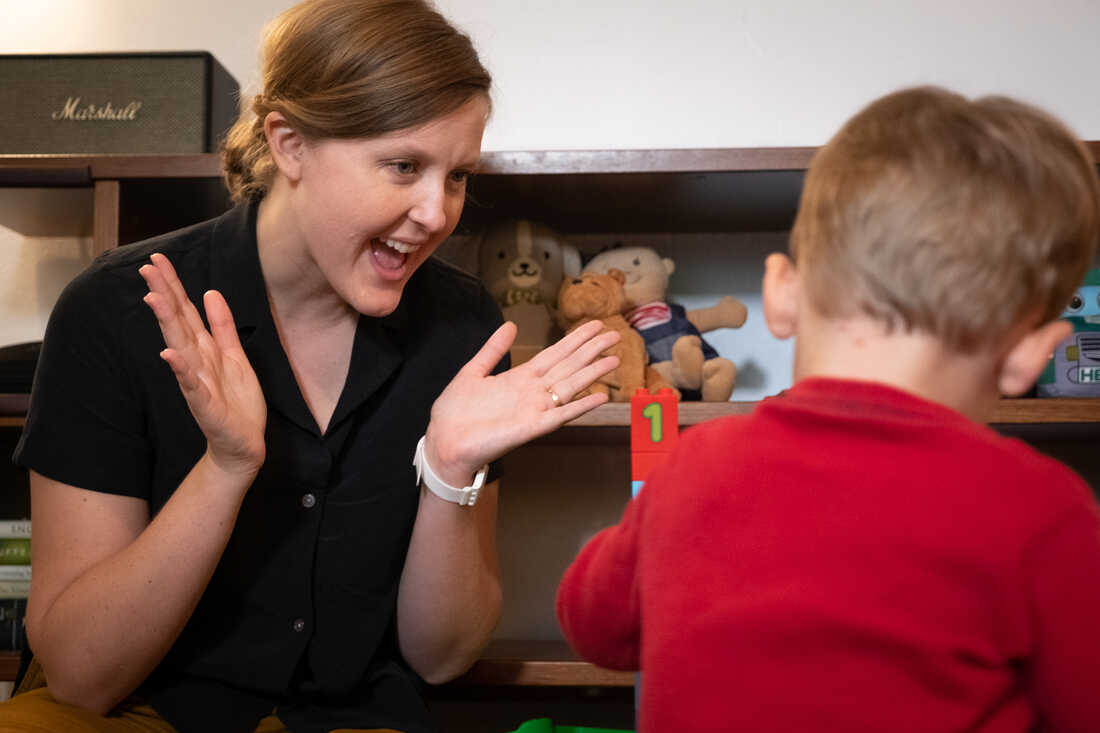 Parent clapping with child