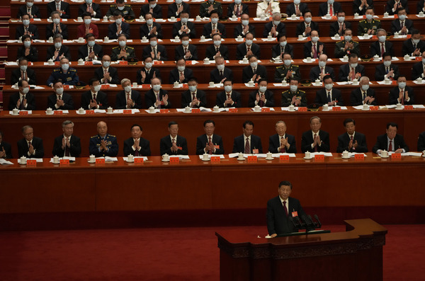 Delegates applaud as Chinese President Xi Jinping speaks.