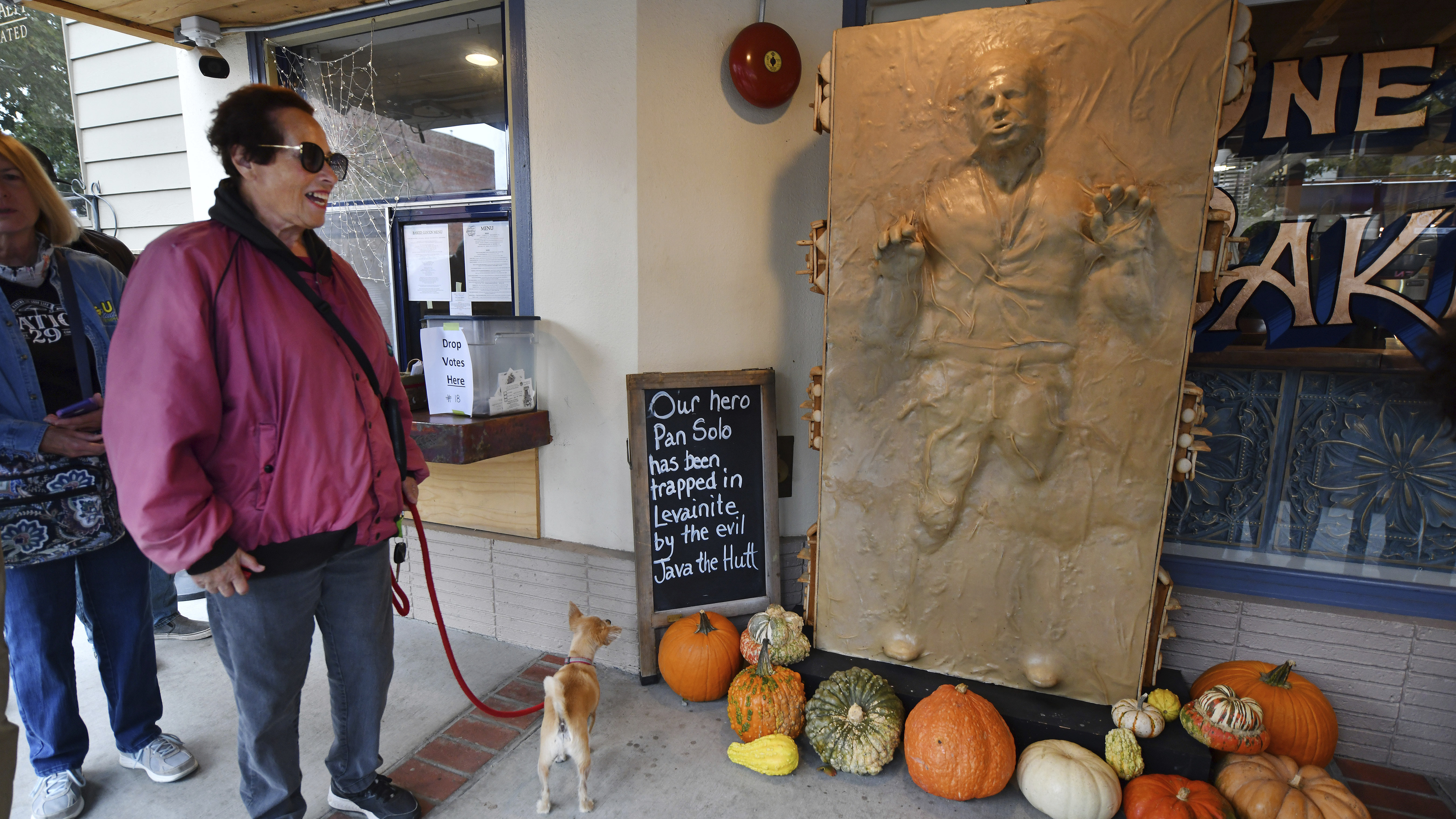 A customer and her dog enjoy a sculpture of "Star Wars" character Han Solo as he was frozen in carbonite made entirely of bread at the One House Bakery in Benicia, Calif.