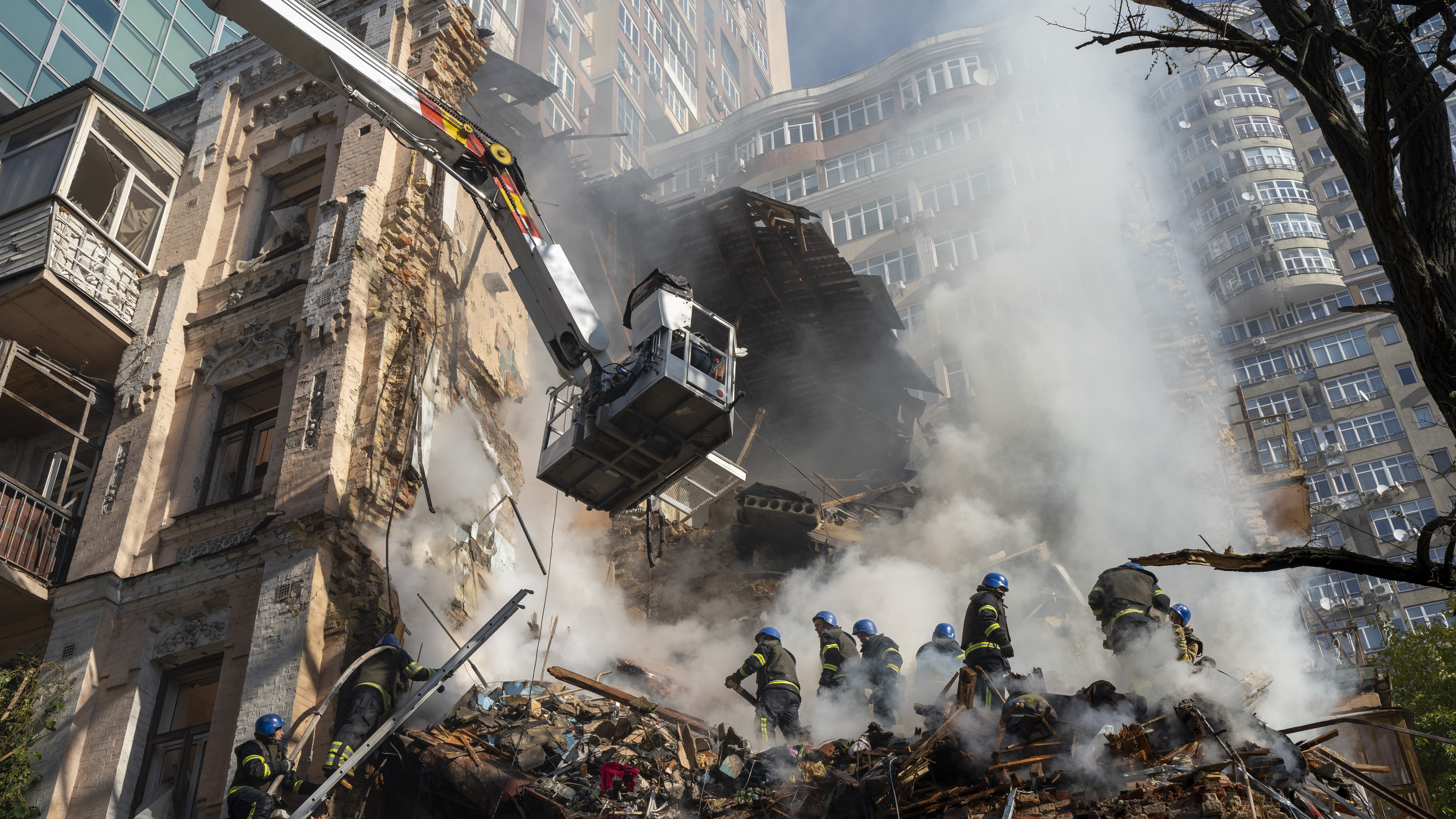 Firefighters work after a drone attack on buildings in Kyiv, Ukraine, Monday. It was the second Monday in a row of Russian strikes on the Ukrainian capital.