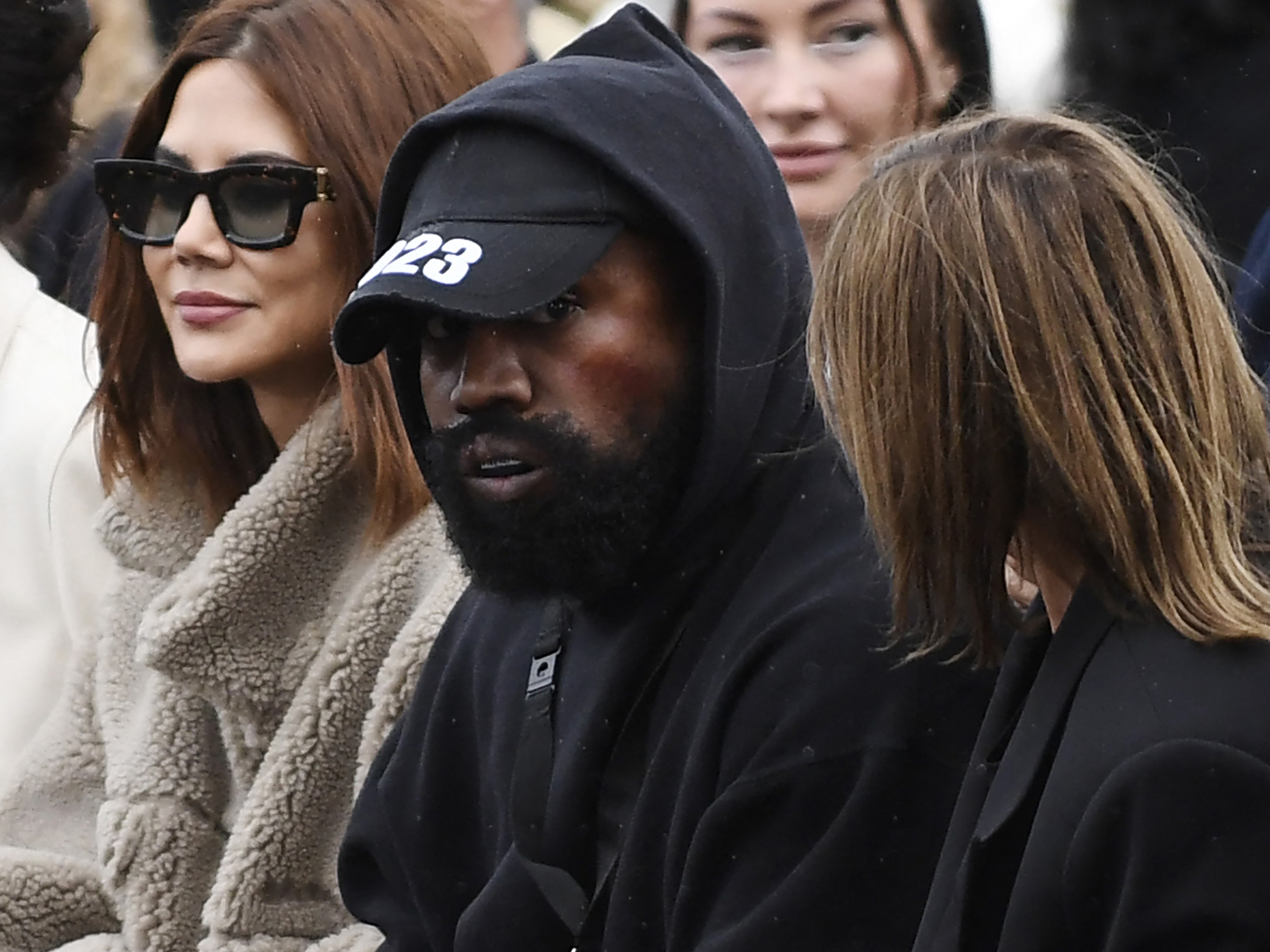 Ye (C), formerly known as Kanye West, attends the Givenchy Spring-Summer 2023 fashion show during the Paris Womenswear Fashion Week, in Paris, on Oct. 2, 2022. (AFP via Getty Images)