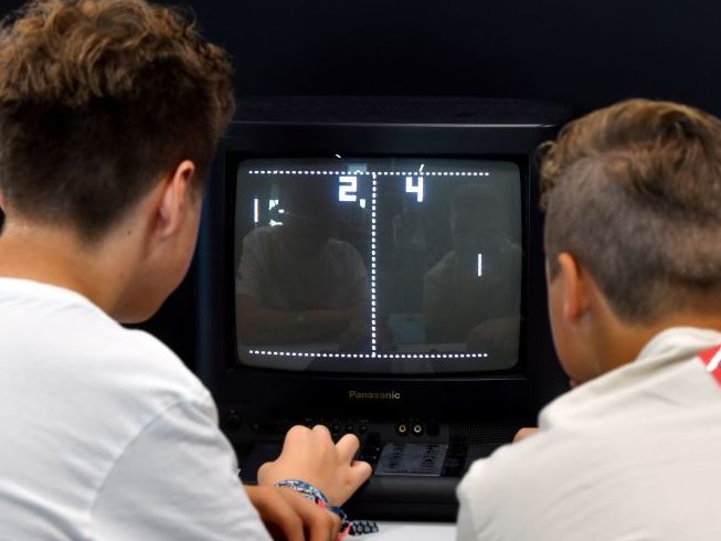 People play Pong in Cologne, western Germany. Researchers are teaching brain cells in a dish to learn the play the game, too. (INA FASSBENDER / AFP via Getty Images)