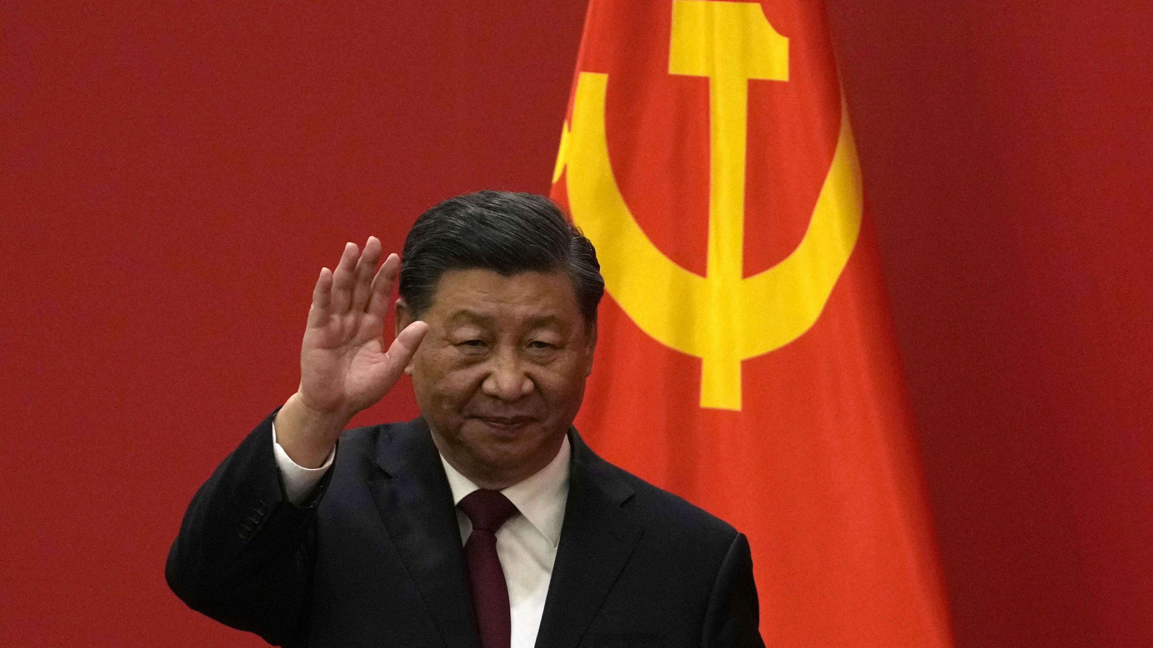 Chinese President Xi Jinping waves at an event to introduce new members of the Politburo Standing Committee in Beijing on Sunday.