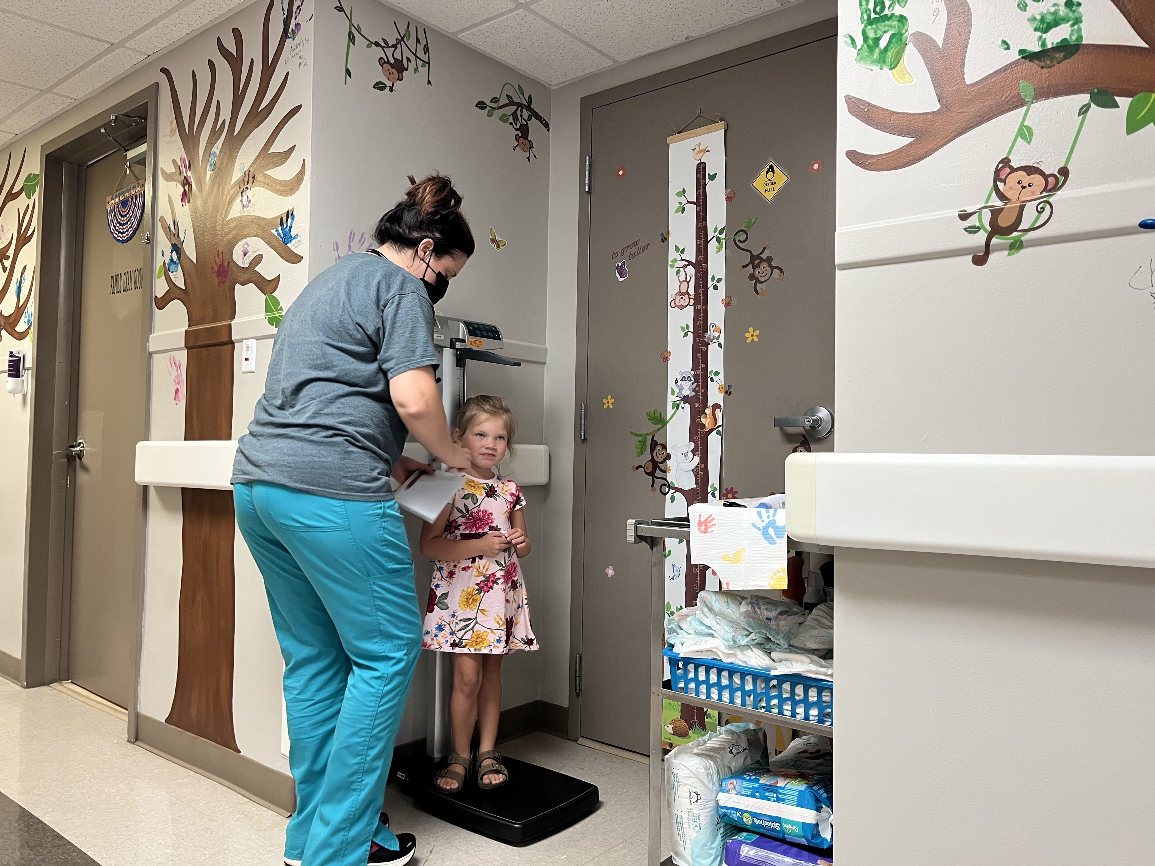 Khloe Tinker, 5, is measured ahead of an appointment at the Doniphan Family Clinic in Doniphan, Missouri. The clinic is the only source for specialized pediatric care in its rural Ozark county. (Sebastián Martínez Valdivia/KBIA)