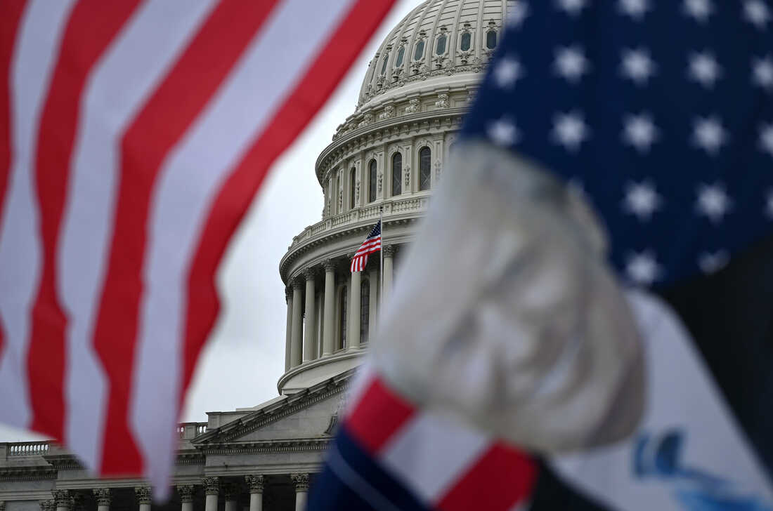 Flags flutter in the wind in front of the US Capitol as supporters of US President Donald Trump gather at the US Capitol on January 5, 2021. (Photo by BRENDAN SMIALOWSKI/AFP via Getty Images)