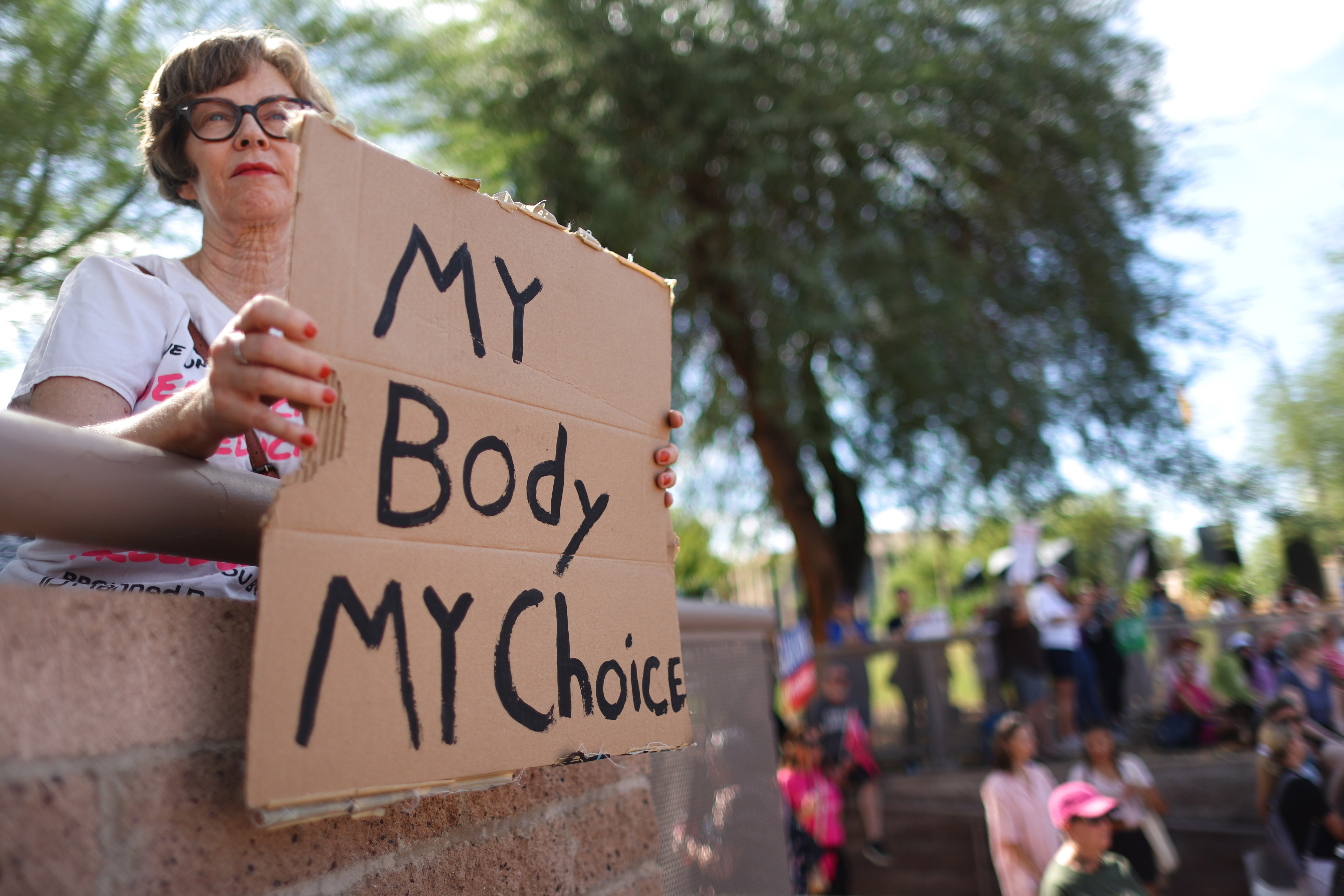 State legislative races are on the front lines of democracy this midterm cycle 2 A protester holds a sign reading 'My Body My Choice' at a Women's March rally where Arizona Secretary of State and Democratic candidate for governor Katie Hobbs spoke outside the state Capitol on Oct. 8 in Phoenix.