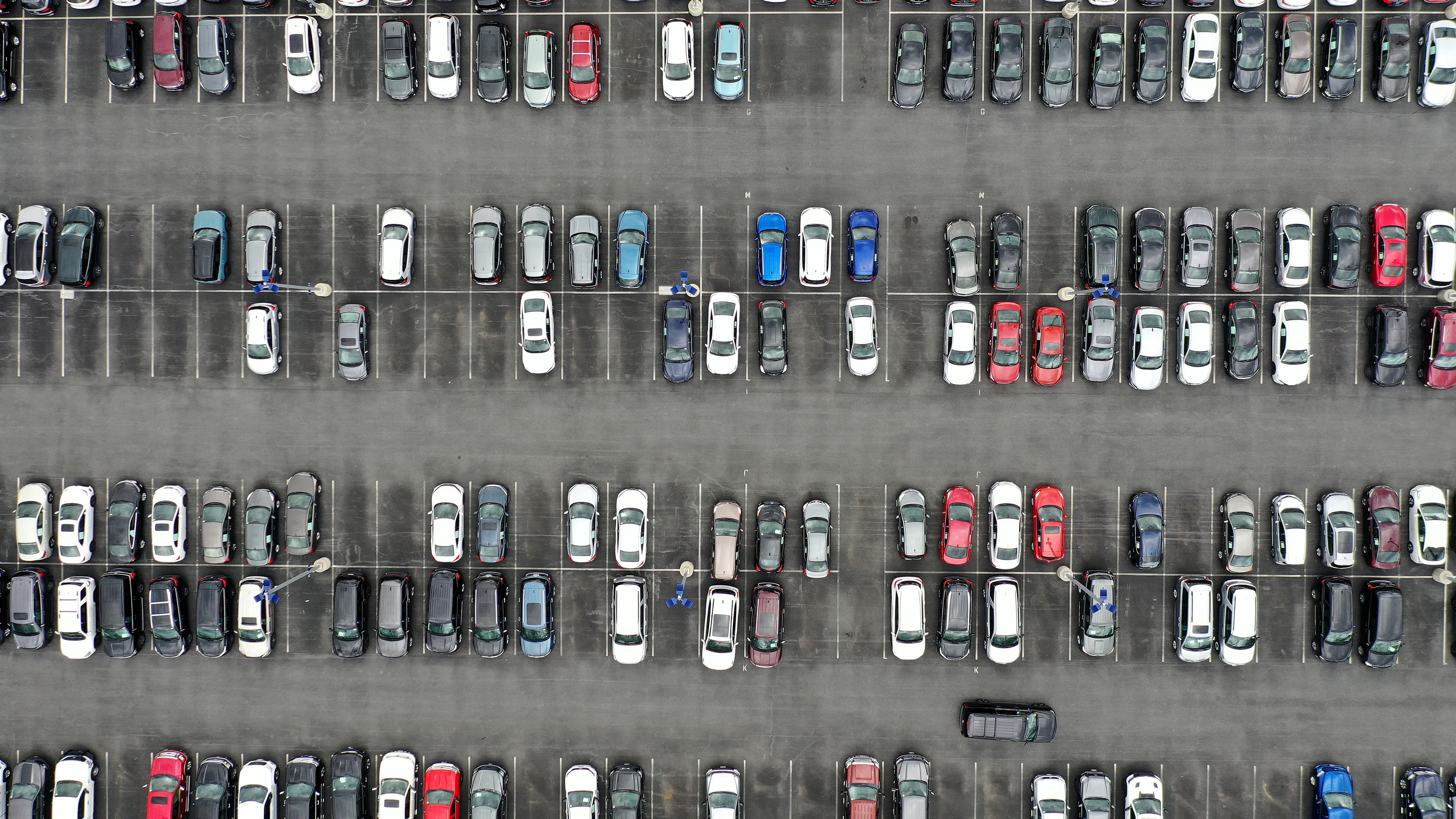 A CarMax lot holds hundreds of used cars and trucks  in Gaithersburg, Md. on April 12. Used car prices have fallen from their recent peaks, but they remain extraordinarily high compared to just a few years ago. And other costs of car ownership are rising, too. (Getty Images)