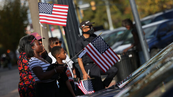 People look on during the Cherry Blossom Festival Veterans Day Parade Sunday in Macon, Ga. Georgia's Senate race, which could decide control of the Senate, might not be resolved for a month.