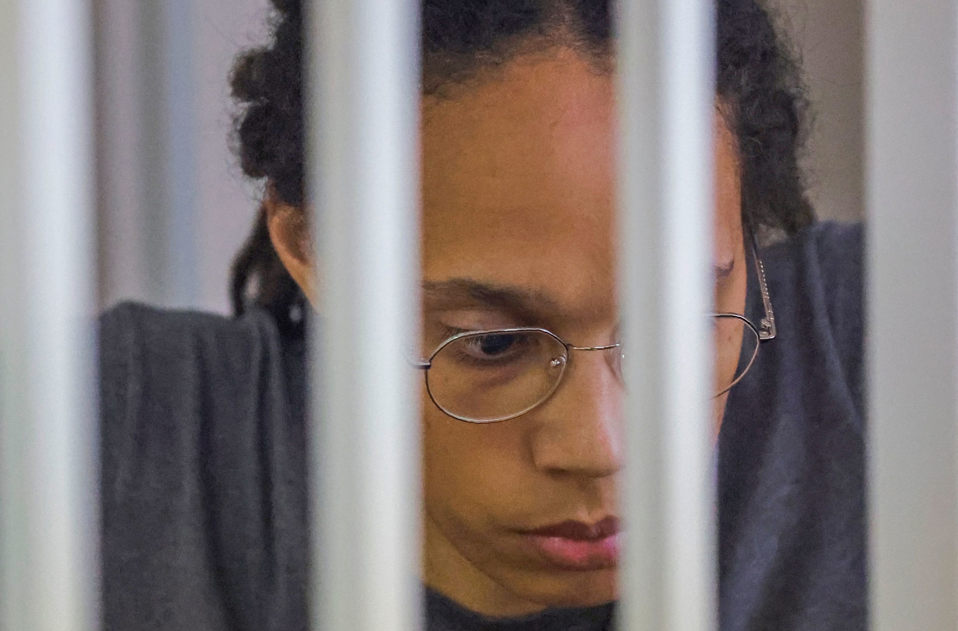 WNBA basketball player Brittney Griner, who was detained at Moscow's Sheremetyevo airport and later charged with illegal possession of cannabis, sits inside a defendants' cage after the court's verdict during a hearing in Khimki outside Moscow, on Aug. 4, 2022. (POOL/AFP via Getty Images)