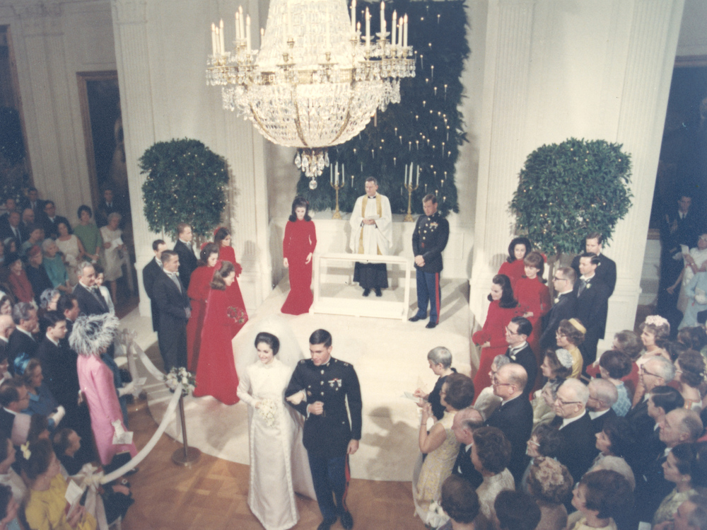 Newlyweds Lynda Bird Johnson Robb and Capt. Charles Robb take their first steps together as husband and wife following their 1967 wedding ceremony in the East Room of the White House.