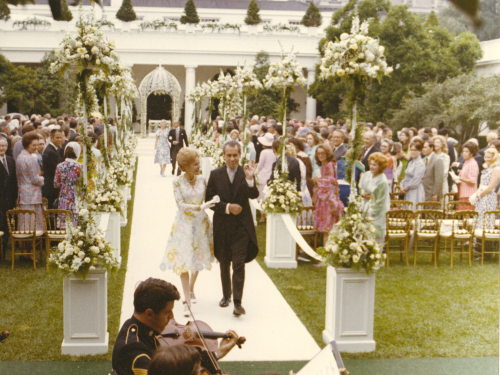 President Richard Nixon and first lady Pat Nixon walk with the departing processional following their daughter Tricia's wedding in the Rose Garden on June 12, 1971.