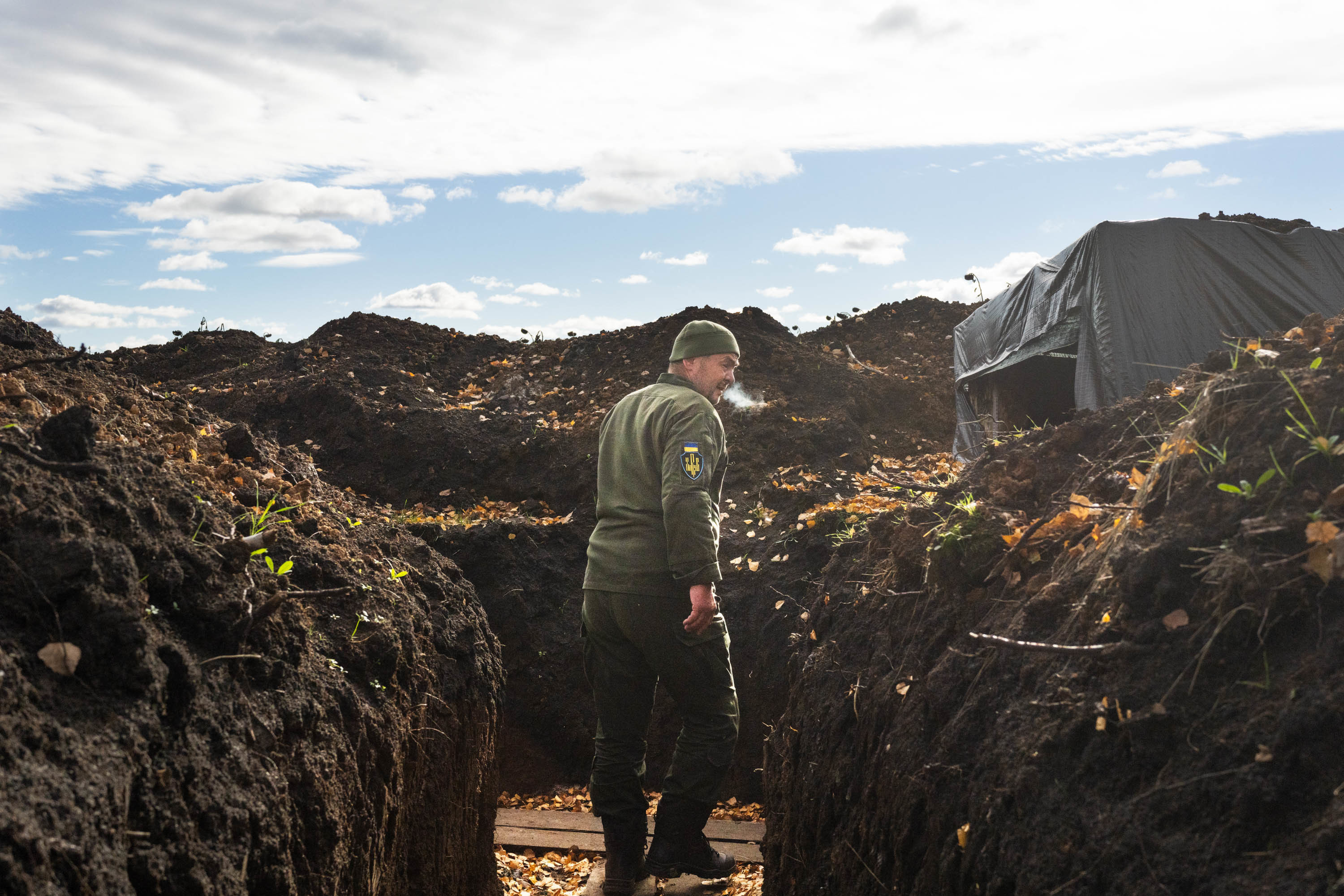 With winter approaching, Ukraine prepares to fight on frozen ground 3 A soldier in Kharkiv region walks through a trench, his breath showing in the cold air.