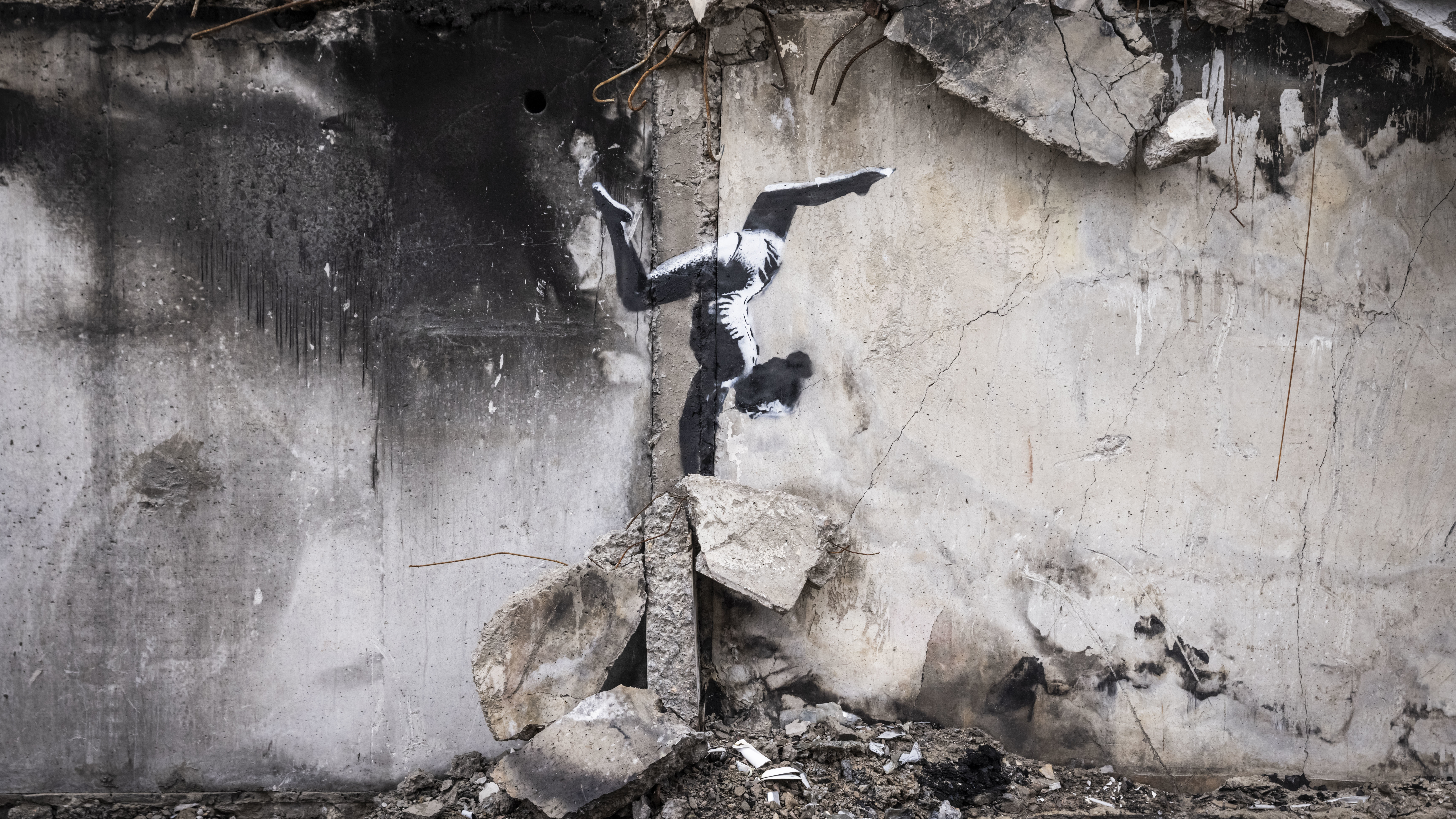 Graffiti of a woman in a leotard doing a handstand is seen on the wall of a destroyed building in Borodyanka on Friday in Kyiv Region, Ukraine. Banksy later confirmed on their Instagram account that this piece was their work.