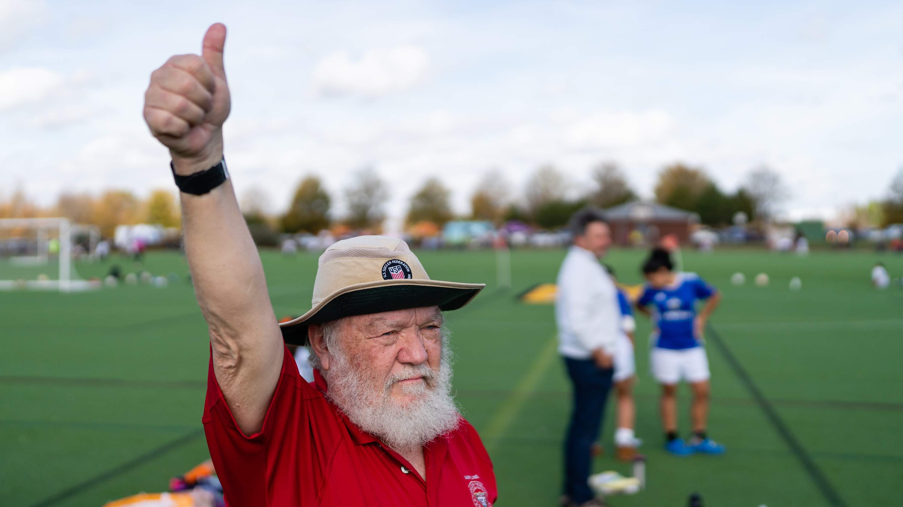 Peter Guthrie signals a teen soccer referee for making a good call during a youth soccer match at Maryland SoccerPlex in Boyds, Md. Guthrie is an instructor with the U.S. Soccer Federation Referee Program and teaches new referees how to umpire youth soccer matches.