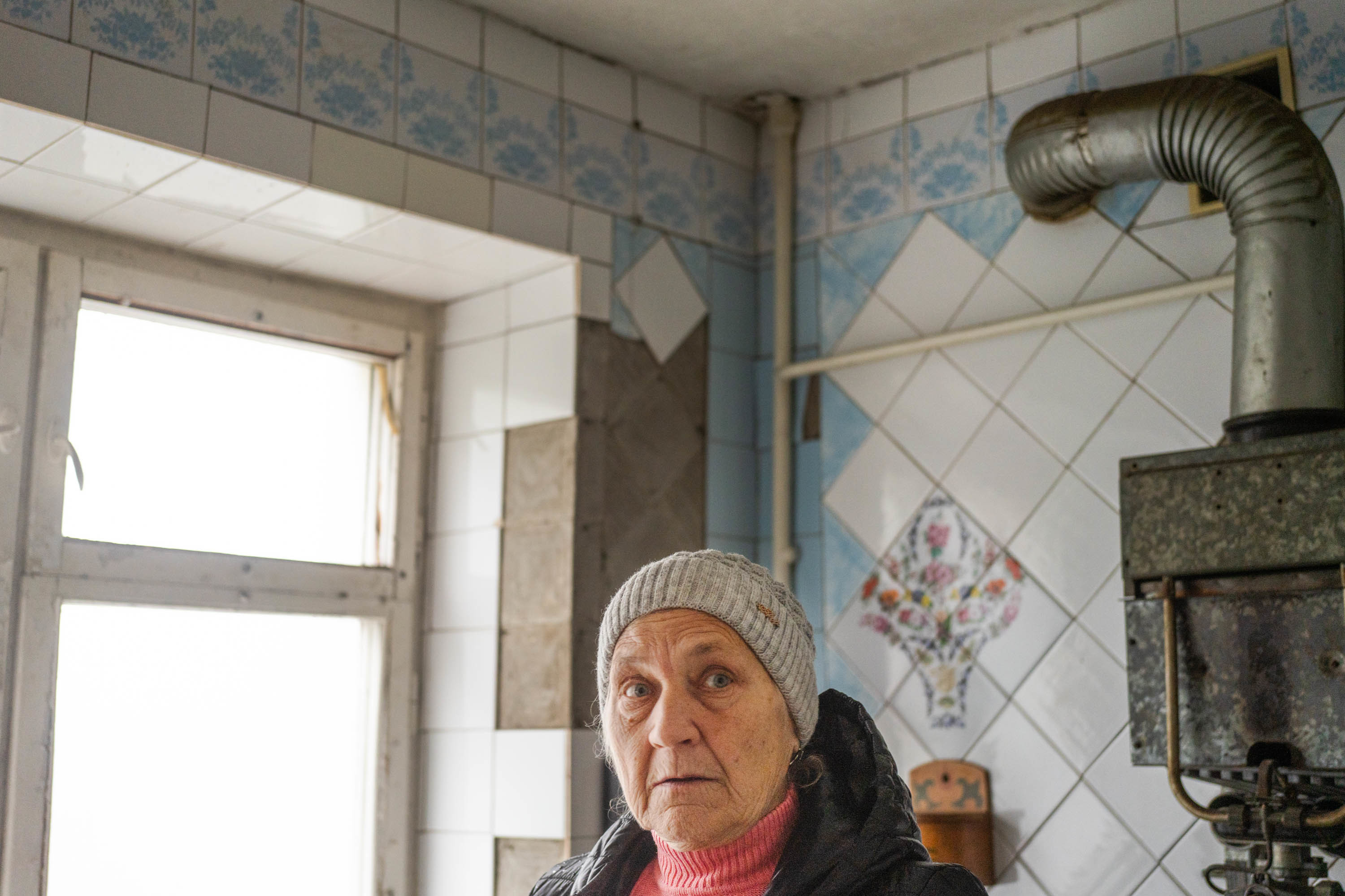 Halyna Zahorodnikh, 71, stands in her kitchen that, like much of her apartment, has sustained damage from nearby shelling. Plastic sheets now hang where the windows were. She is one of millions of Ukrainians facing a winter that's essentially being weaponized against them. (NPR)