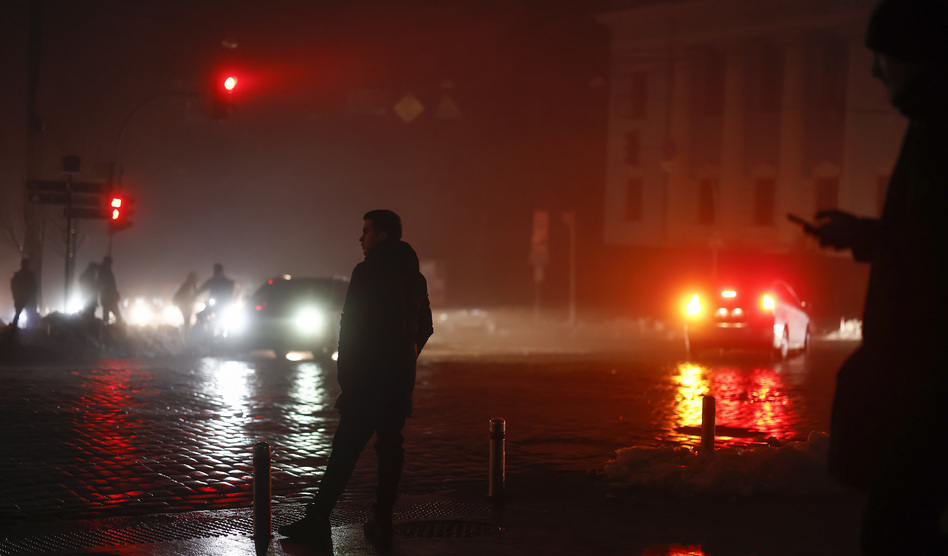 Ukrainians walk through the unlit streets of the capital Kyiv on Thursday, a day after Russian airstrikes knocked out electricity, heating and water to much of the country. With Russian troops faring poorly on the battlefield, Russia has launched a widespread bombing campaign directed at civilian infrastructure in Ukraine.