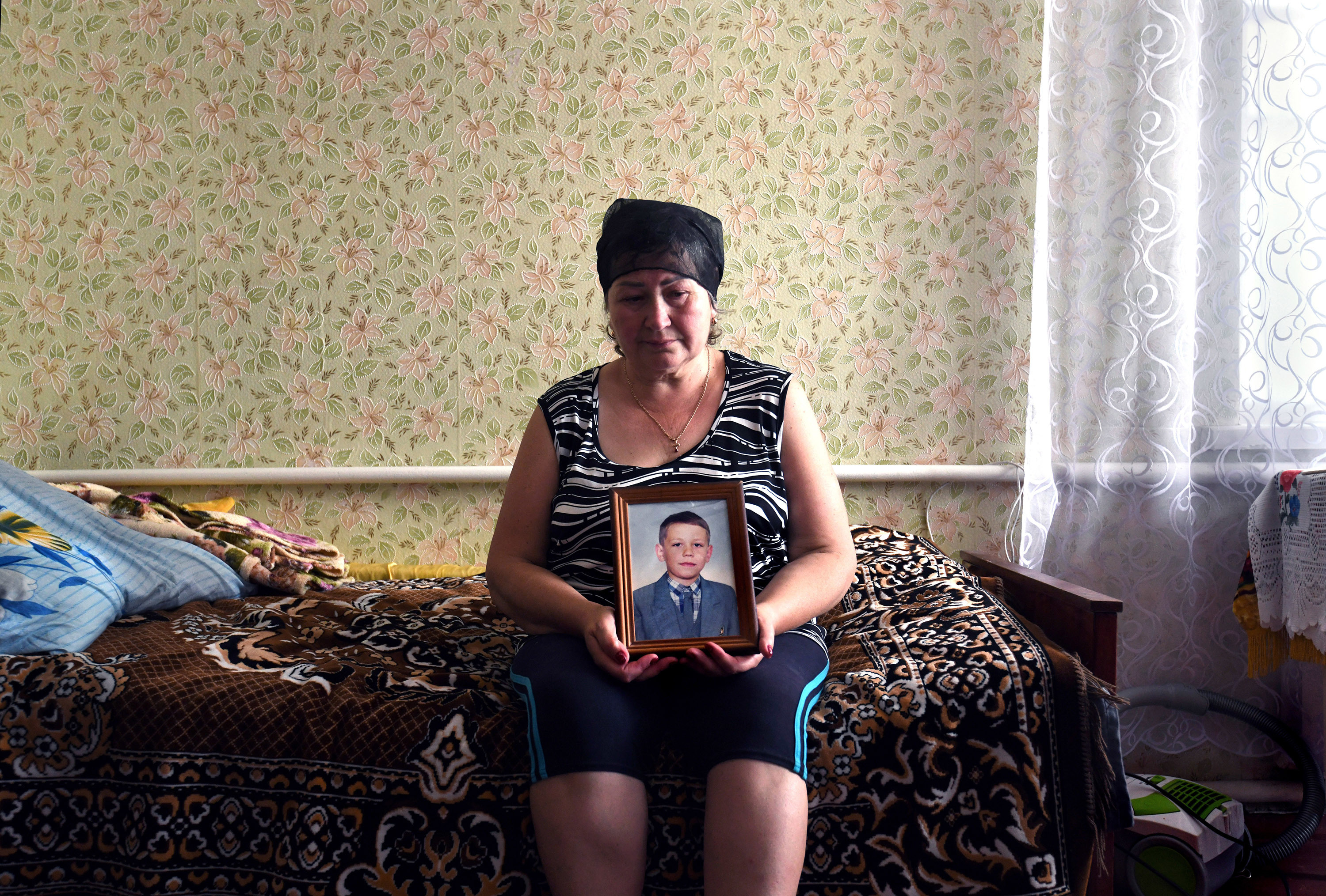 There have been 50,000 alleged war crimes in Ukraine. We worked to solve one 2 Oksana Breus holds a photo of her son, Oleksandr, at her home in Bobrovytsia.