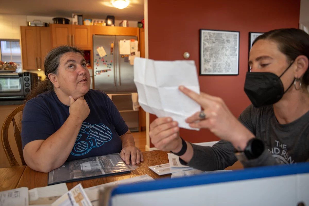 Lucy Greco (left), a web-accessibility specialist at the University of California, Berkeley, is blind. She reads most of her documents online, but employs Liza Schlosser-Olroyd as an aide to sort through her paper mail every other month, to make sure Greco hasn't missed a bill or other important correspondence.