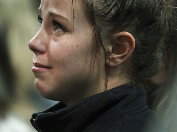 A person attending a vigil for the four University of Idaho students who were killed on Nov. 13, 2022, cries as she listens to family members talk about the victims, Wednesday, Nov. 30, 2022, in Moscow, Idaho.