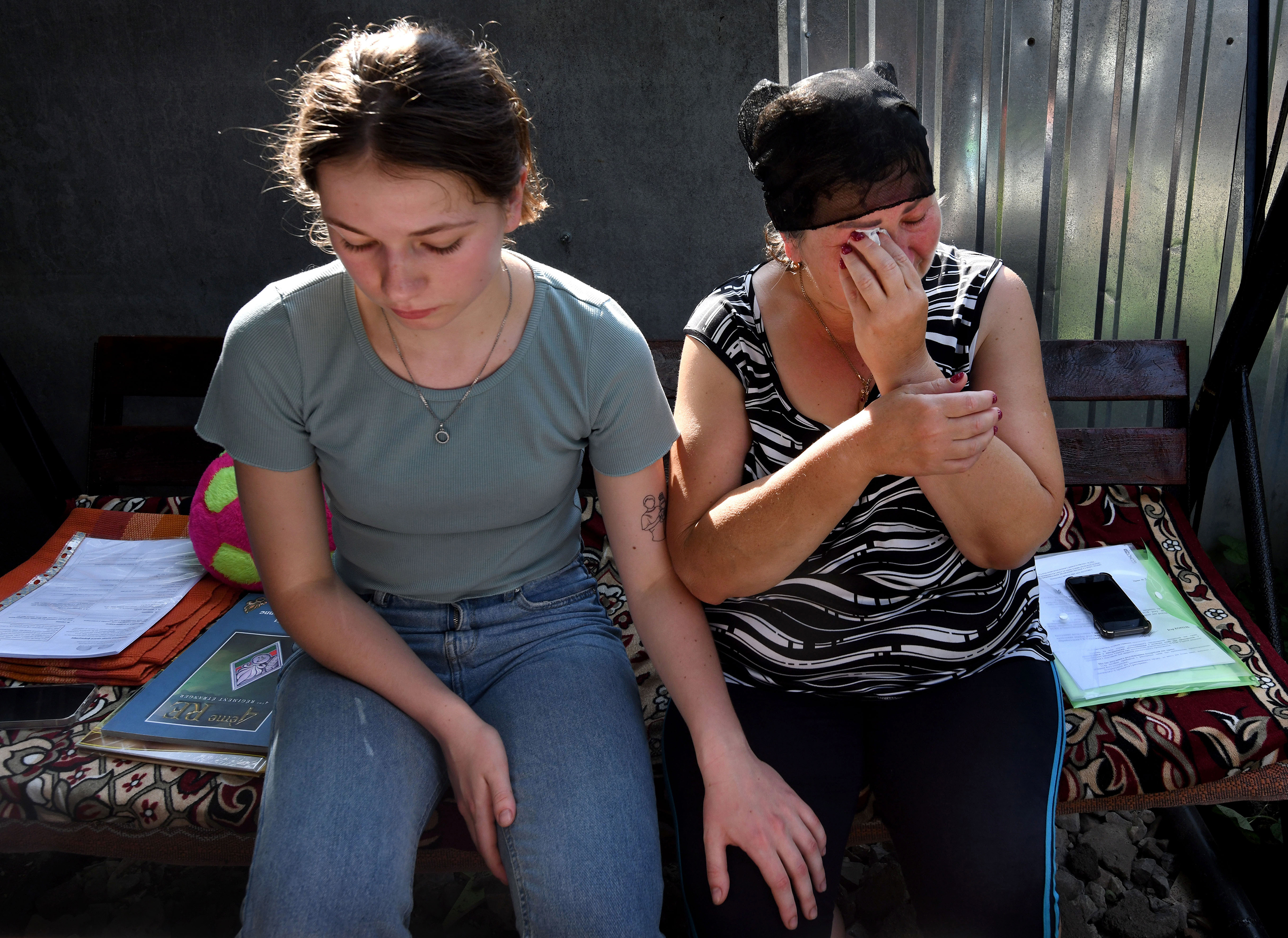 There have been 50,000 alleged war crimes in Ukraine. We worked to solve one 4 Oleksandr's sister Anya Breus comforts their mother, Oksana, as she cries.