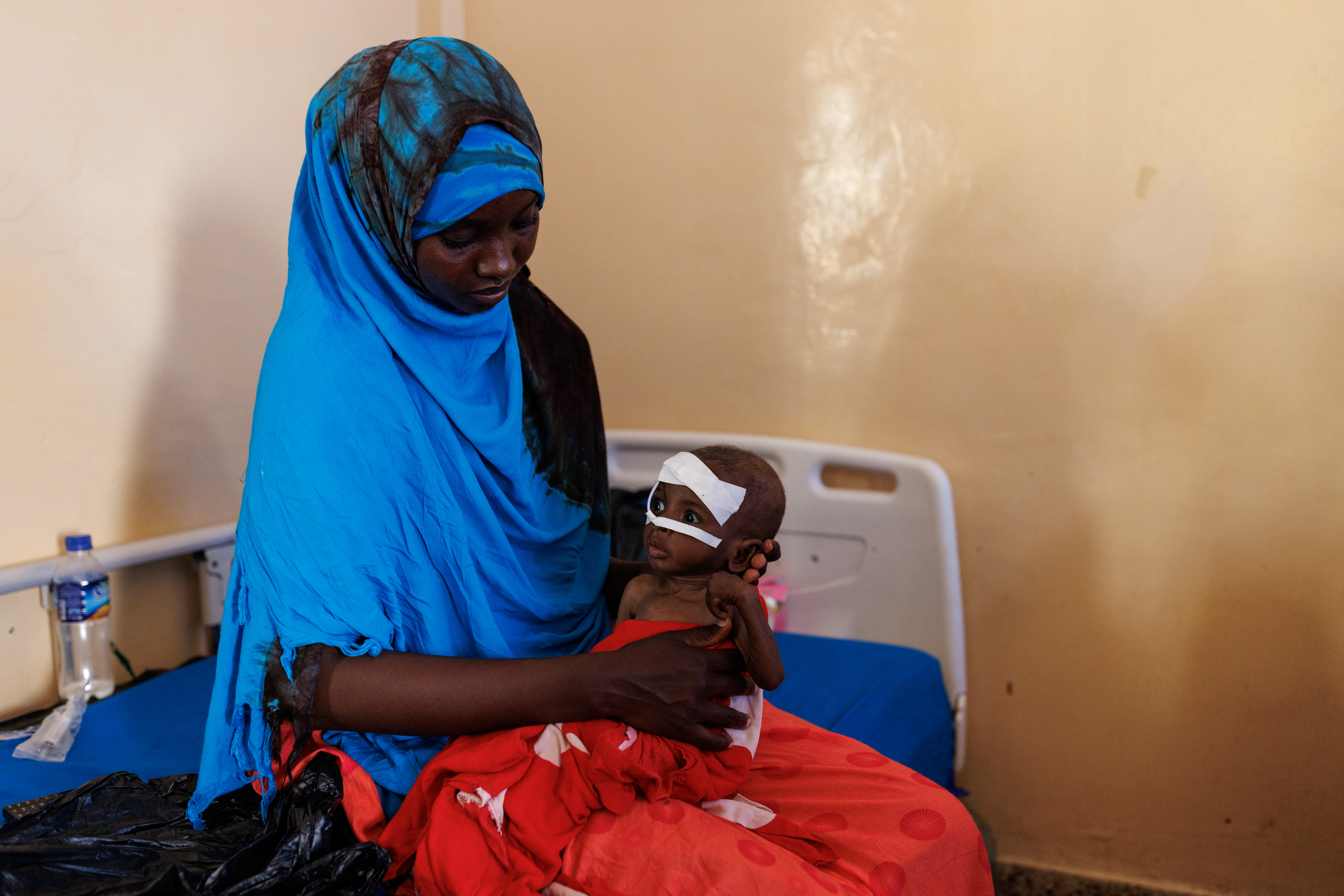 Fahir Mayow holds her nephew, eight-month-old Ahmed Noor, at Banadir Hospital in Mogadishu on Monday. Ahmed arrived at the hospital one week ago, weighing 3.5 kilograms, just under 8 pounds. (Luke Dray for NPR)
