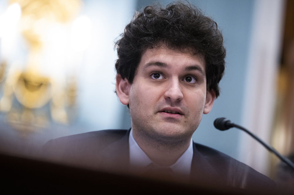 Sam Bankman-Fried's crypto empire abruptly collapsed last month. Now he's facing multiple criminal fraud charges over the handling of billions of dollars by the FTX platform. He's seen here speaking during a House Agriculture Committee hearing in May. (CQ-Roll Call via Getty Images)