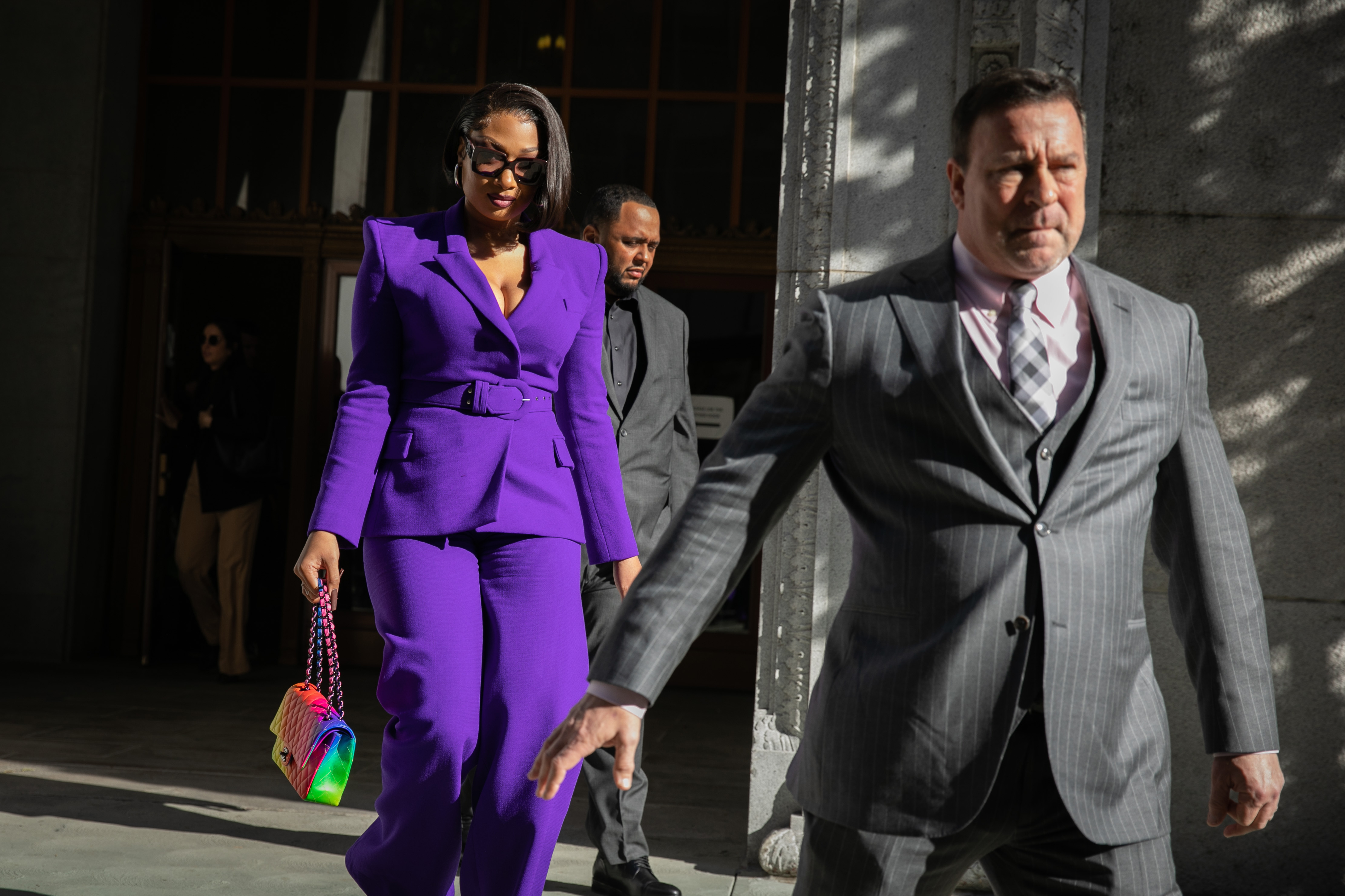 Megan Thee Stallion, whose legal name is Megan Pete, makes her way from the Hall of Justice to the courthouse to testify in the trial of Rapper Tory Lanez for allegedly shooting her on Tuesday, Dec. 13 in Los Angeles, CA. (Los Angeles Times via Getty Images)