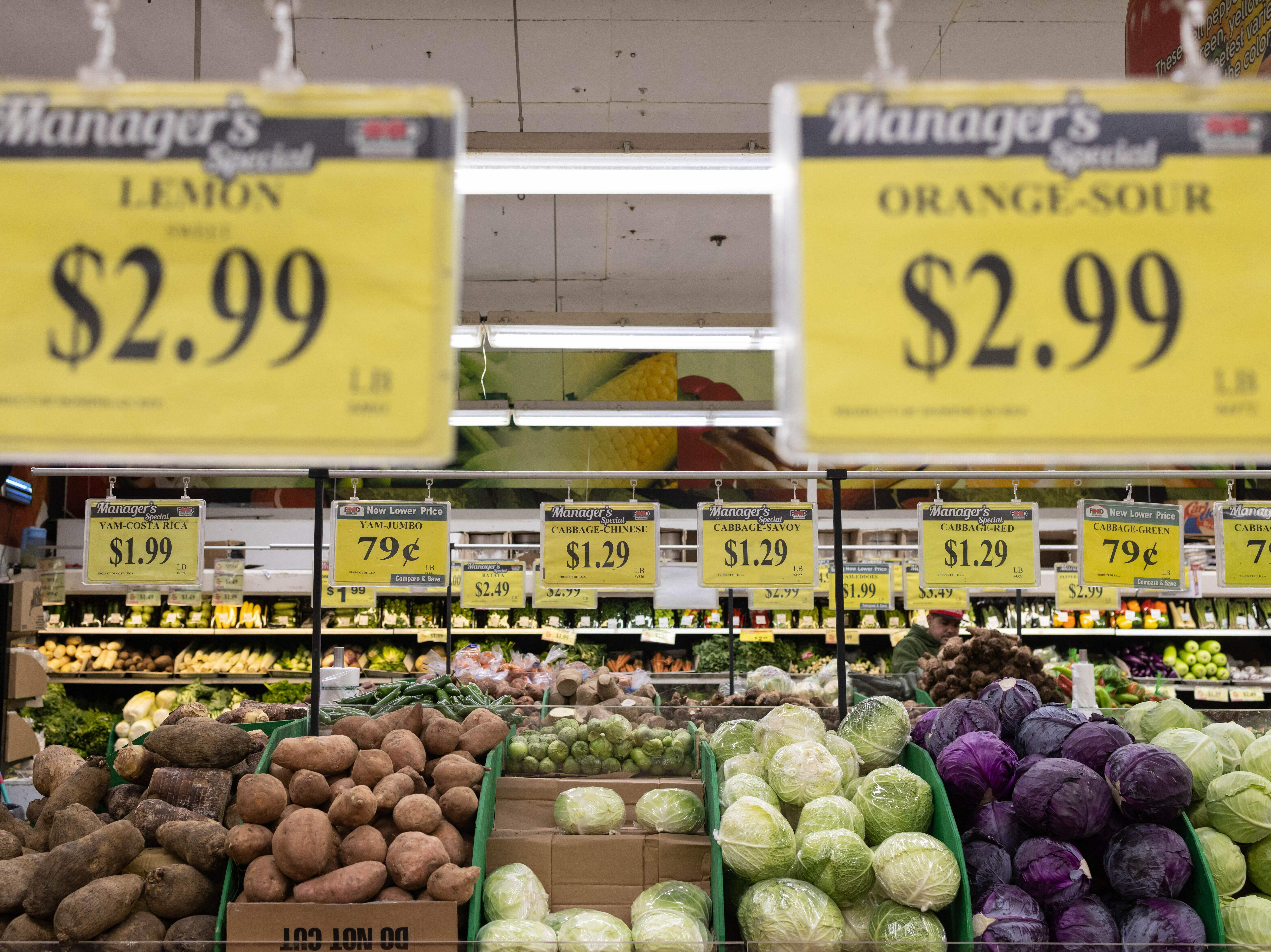 Price tags are displayed at a New York City supermarket  on Dec. 14. Inflation has eased recently, but more evidence is needed to show that price increases are coming down in the long term, Fed Chair Powell said Wednesday. (AFP via Getty Images)