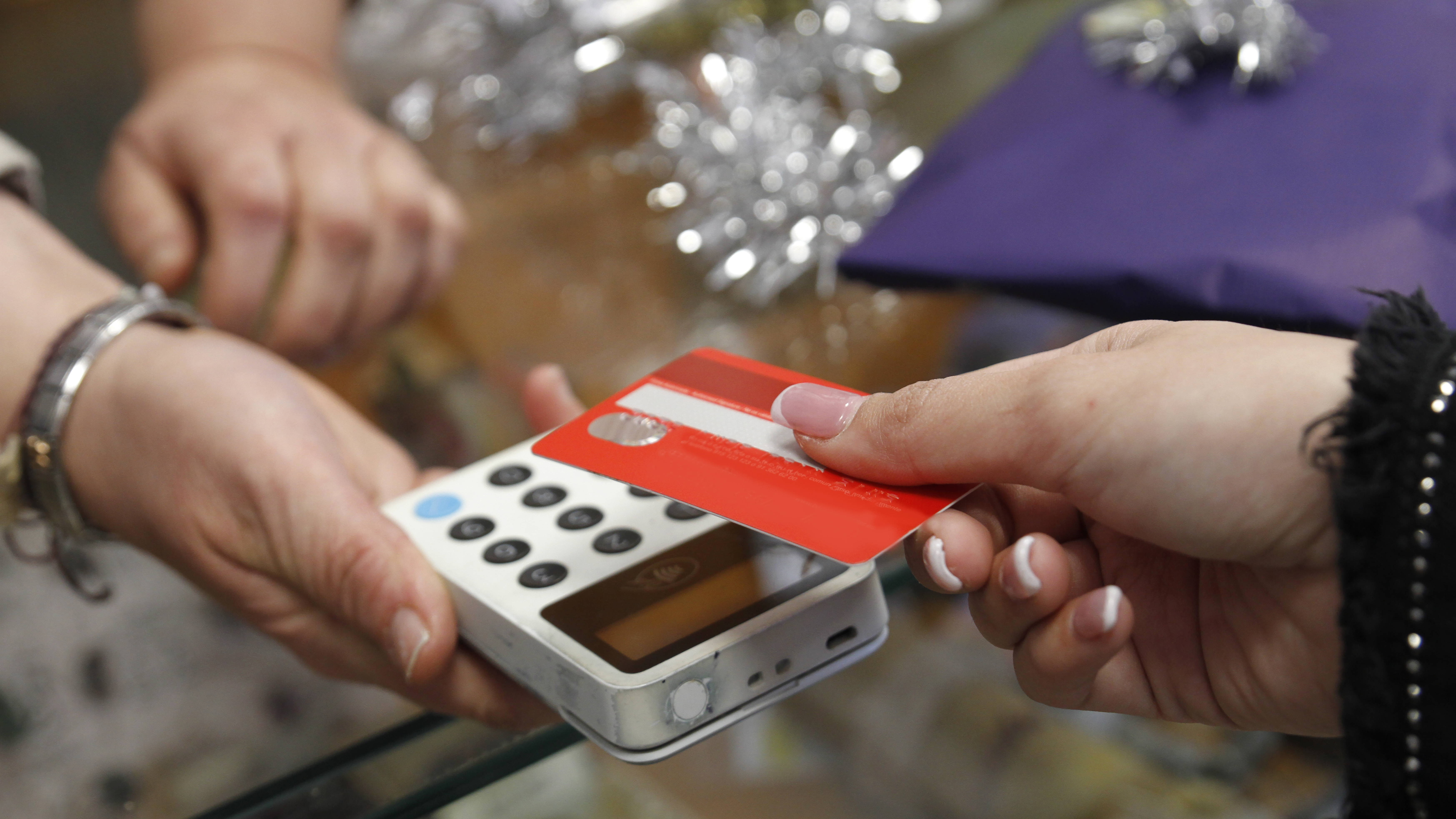 Retail spending dips as holiday sales bite into inflation