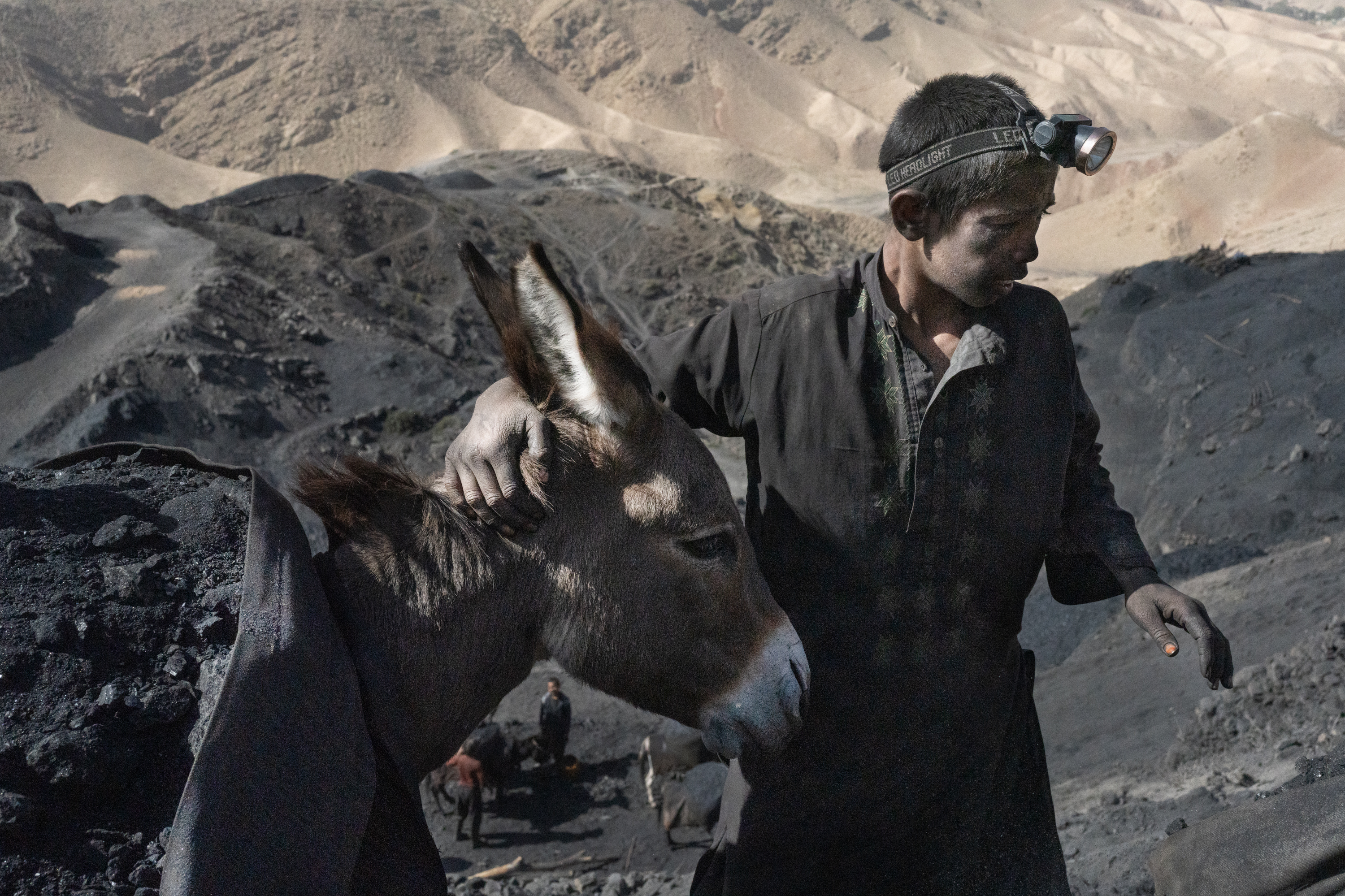 In Afghanistan, coal mining relies on the labor of children 7 A boy guides a loaded donkey over paths on the steep mountain where the coal mine is located.