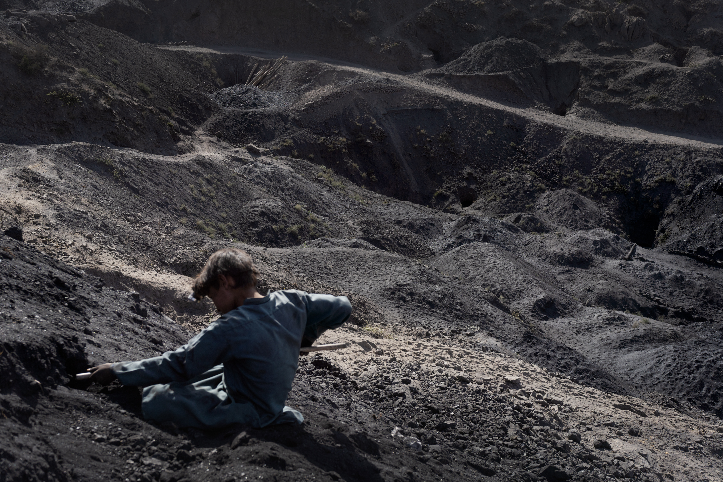 In Afghanistan, coal mining relies on the labor of children 9 Mansour plays in the dirt on the edge of the mountain where the mine entrance is located.