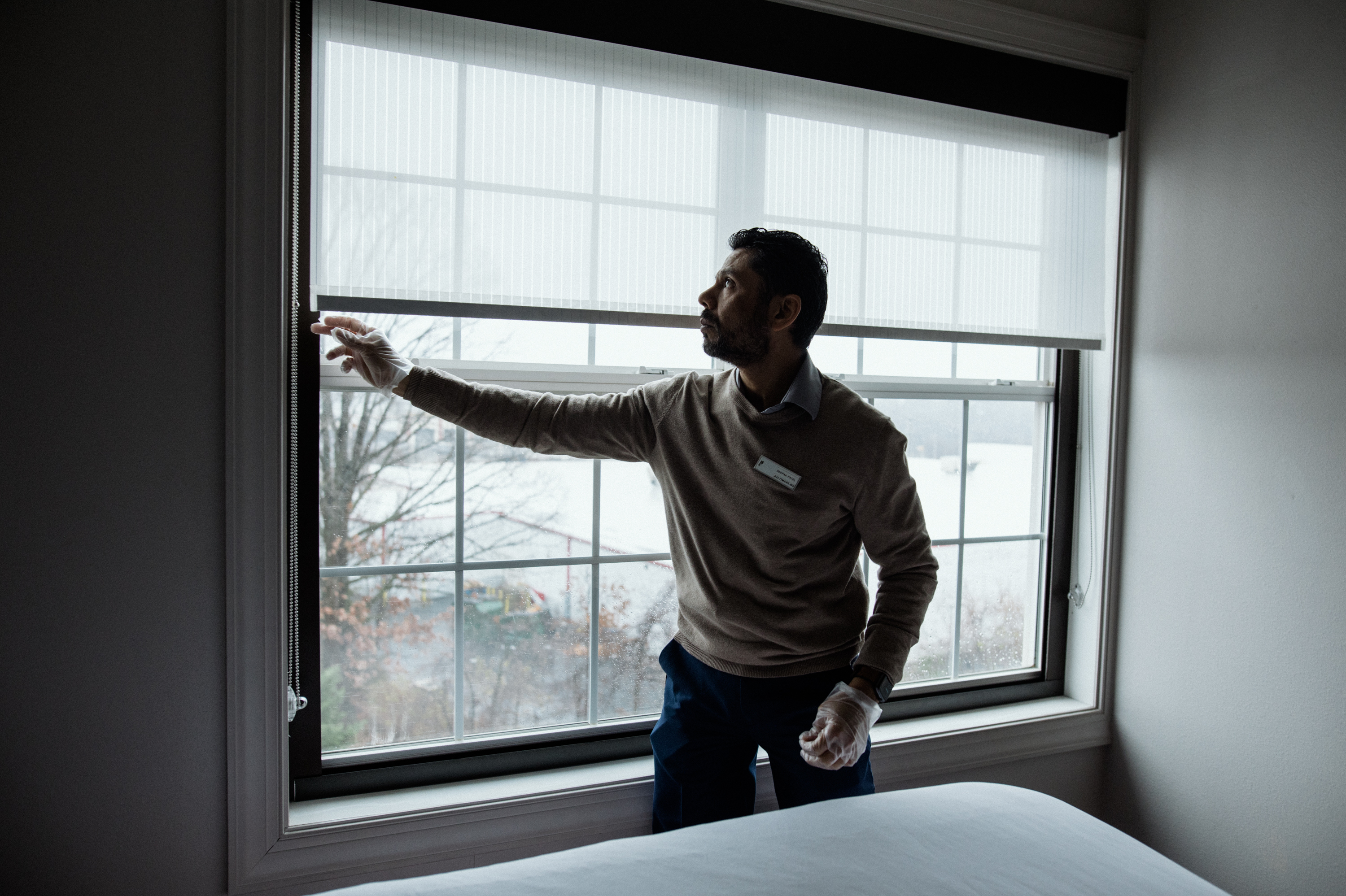 Deepak Patel, 43, conducts a room inspection at the Country Inn and Suites, Baltimore North, a hotel he owns and manages with his family in Rosedale, Maryland. (Rosem Morton for NPR)