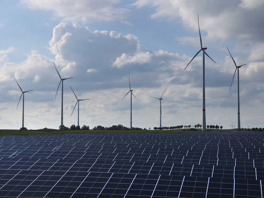 PRENZLAU, GERMANY - JUNE 02: Wind turbines spin behind a solar energy park on June 02, 2022 near Prenzlau, Germany. (Photo by Sean Gallup/Getty Images)