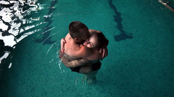 Sgt. Mykhailo (Misha) Varvarych, 28, and his fiance, Iryna (Ira) Botvynska, 19, take part in a therapeutic swimming activity at Moldova pool in Truskavets, Ukraine.