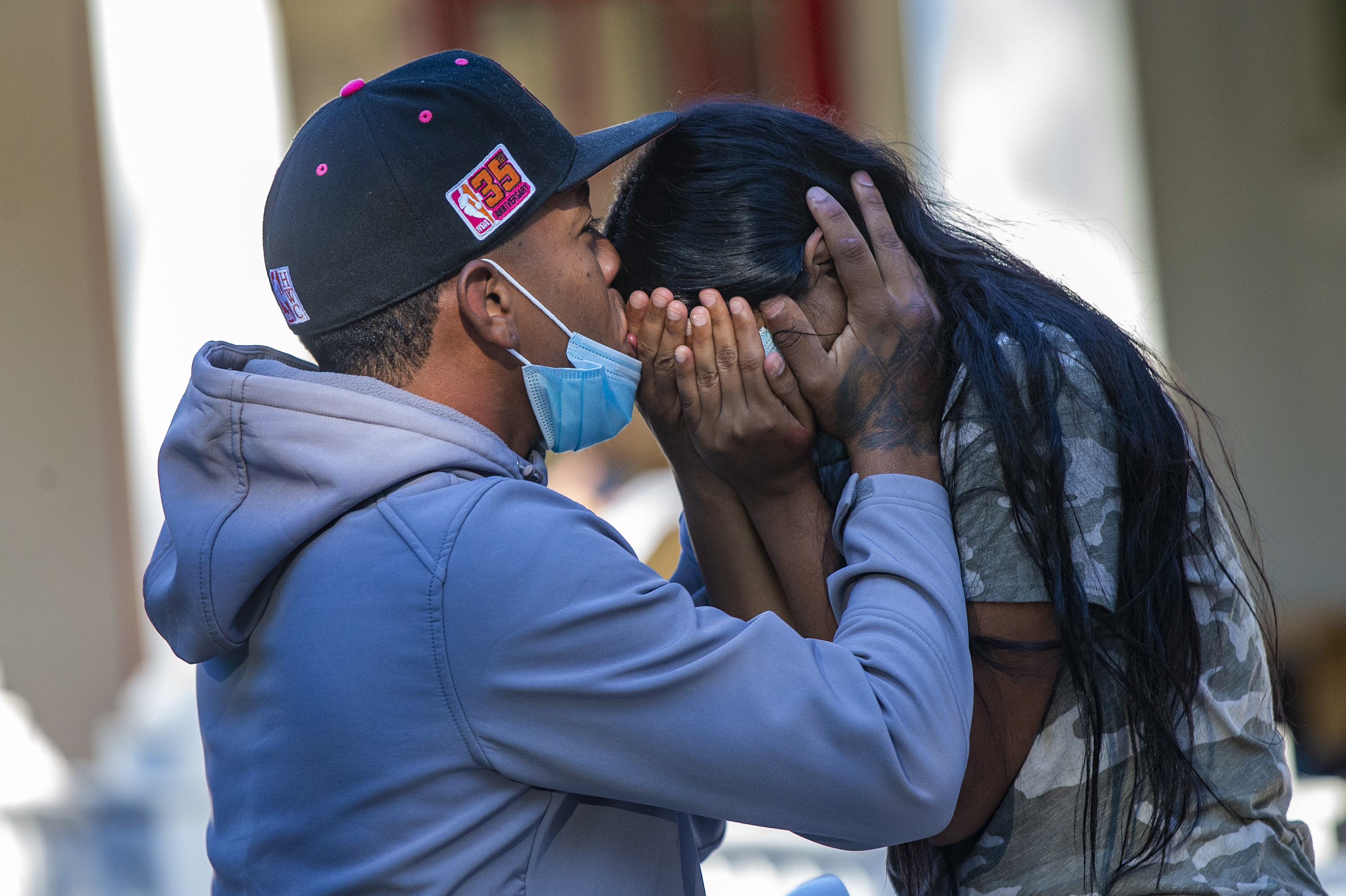 A young migrant couple embraces on the porch of St. Andrew's Parish House in Edgartown. Nearly 50 Venezuelans were flown to the island from Texas under what they said was a false pretense.  Full story here.