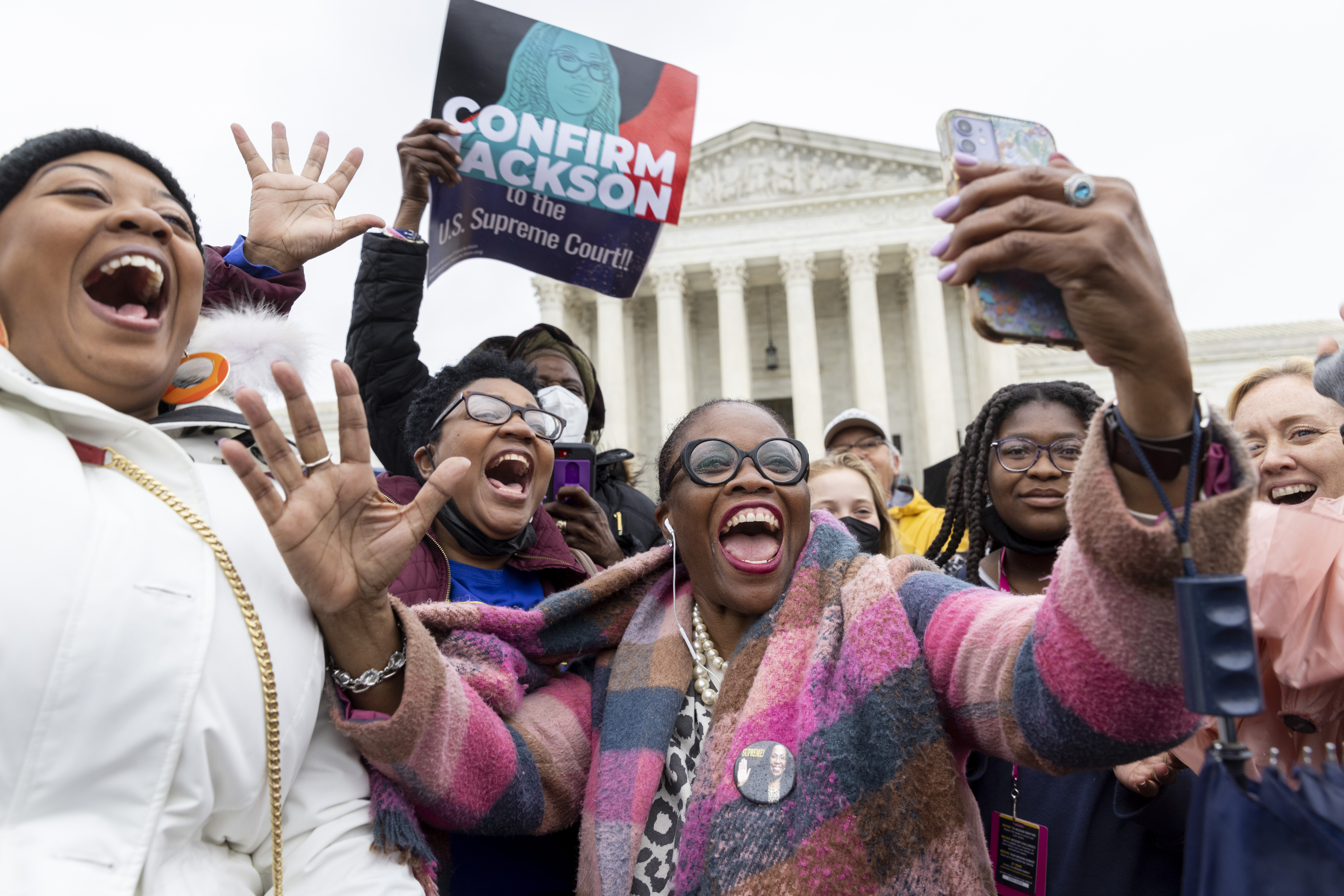 From left to right: Nicole Tinson from L.A., Teresa Roberts, from Shannon, Mississippi, Sheila Carson, from D.C. and Regina Langley, middle, from New Jersey. Langley was holding a cell phone watching the Senate voting on the conformation of Ketanji Brown Jackson to the Supreme Court. Full story here.