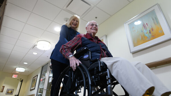 Paula Naylor pushes her father, Paul Romanello, with his wheelchair on Dec. 21 in Tulsa, Okla. Romanello was recently celebrated by the Centenarians of Oklahoma when he turned 100 years old.