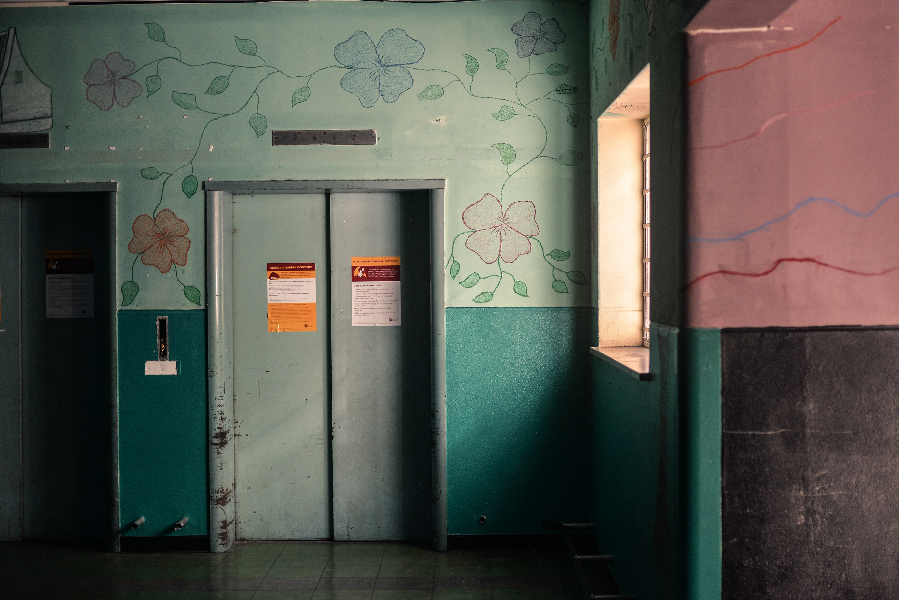 Inside South Africa's 'hijacked' buildings: 'All we want is a place to call home' 3 Murals and bright colors adorn the walls of a former elevator lobby in Cissie Gool House, an abandoned hospital that now houses over 1,000 people in the Woodstock neighborhood of Cape Town.