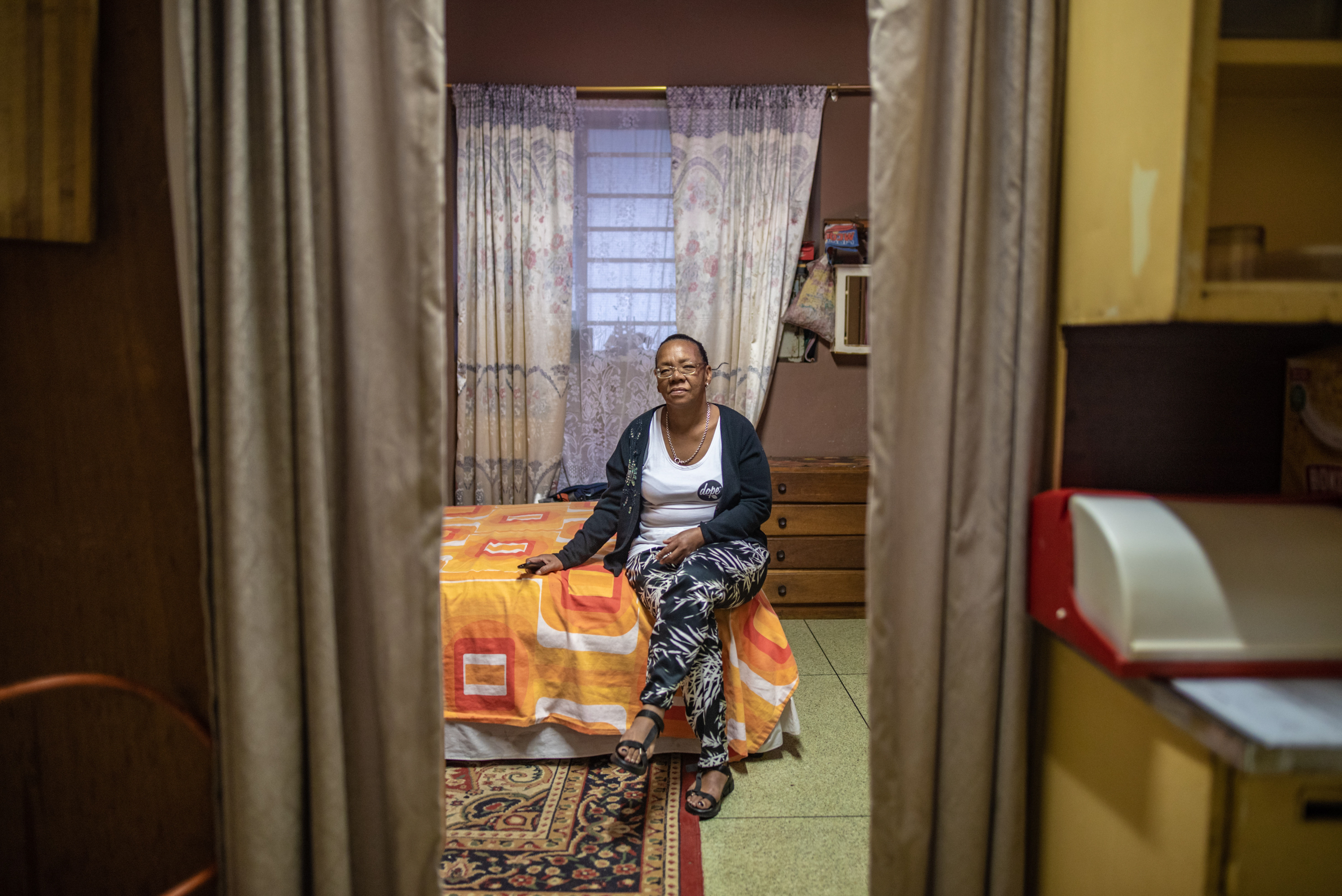 Inside South Africa's 'hijacked' buildings: 'All we want is a place to call home' 7 Elizabeth Daniels, 52, photographed in her room at Cissie Gool House, has used plywood panels and fabric to divide up her room and make it feel more like a home.