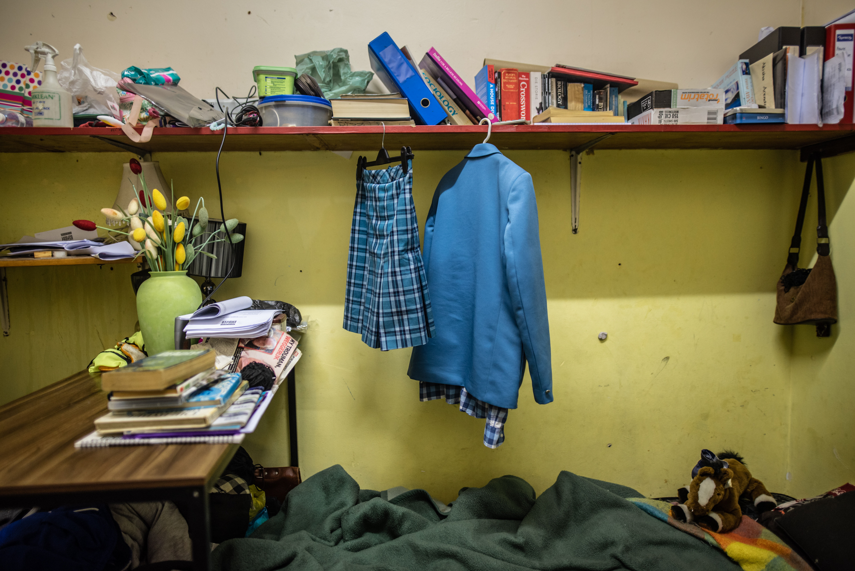 Inside South Africa's 'hijacked' buildings: 'All we want is a place to call home' 11 School clothes belonging to 14-year-old Akisha Arendse hang on a shelf in the room she shares with her father in Cissie Gool House.